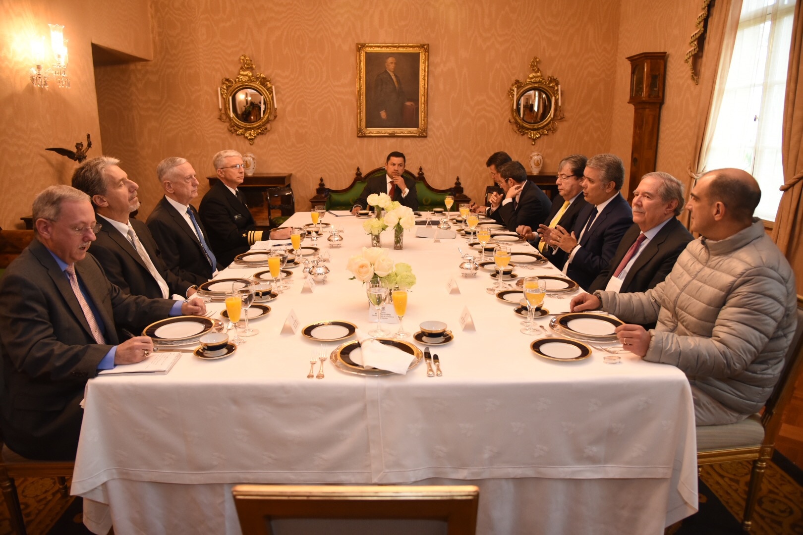 Colombia's president is flanked at a conference table by nine men, including Defense Secretary James N. Mattis.