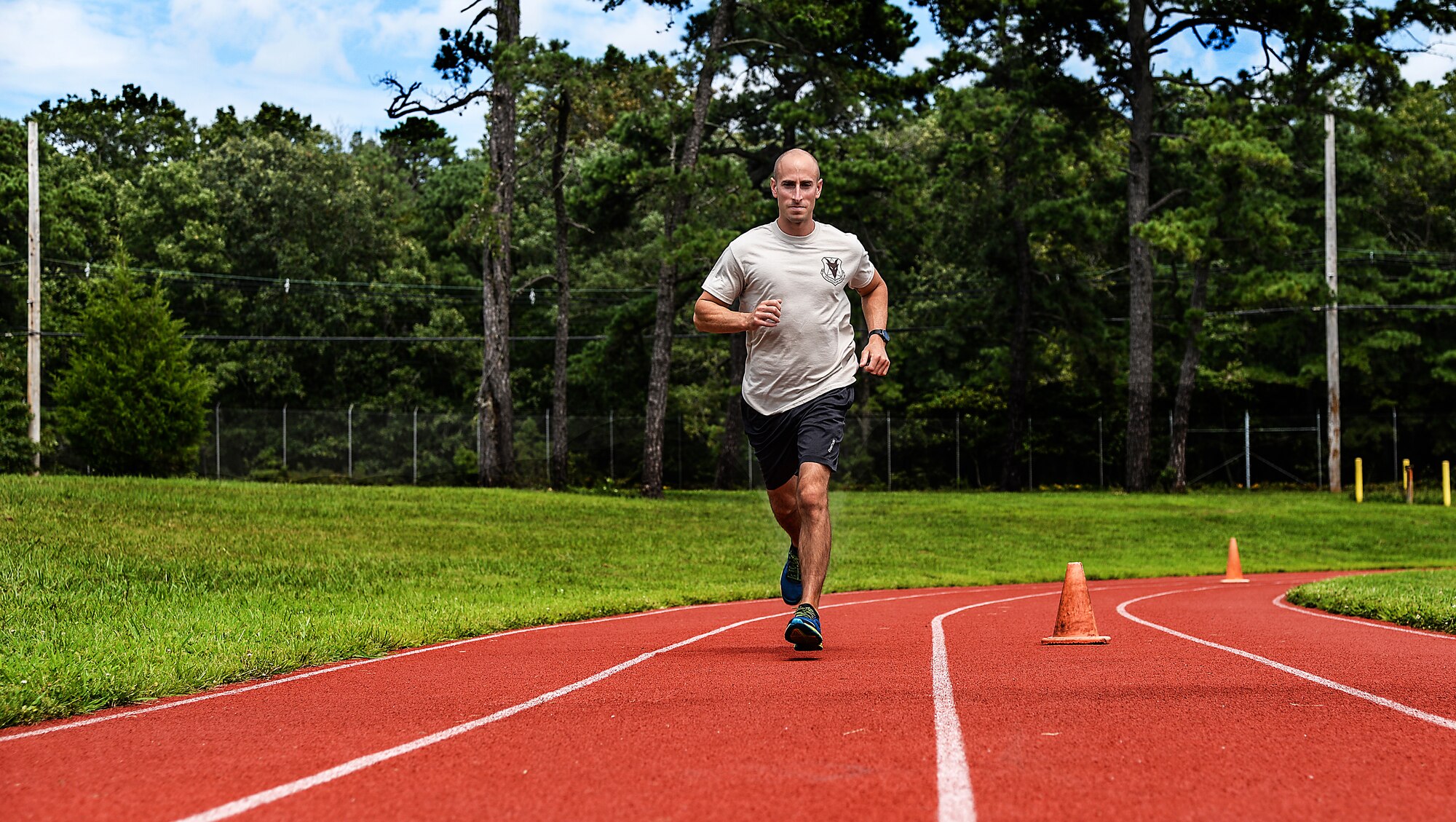 A picture of U.S. Air Force Staff Sgt. Mark A. Perna, a pavements and construction equipment journeyman with the 177th Civil Engineer Squadron, running on the base track.