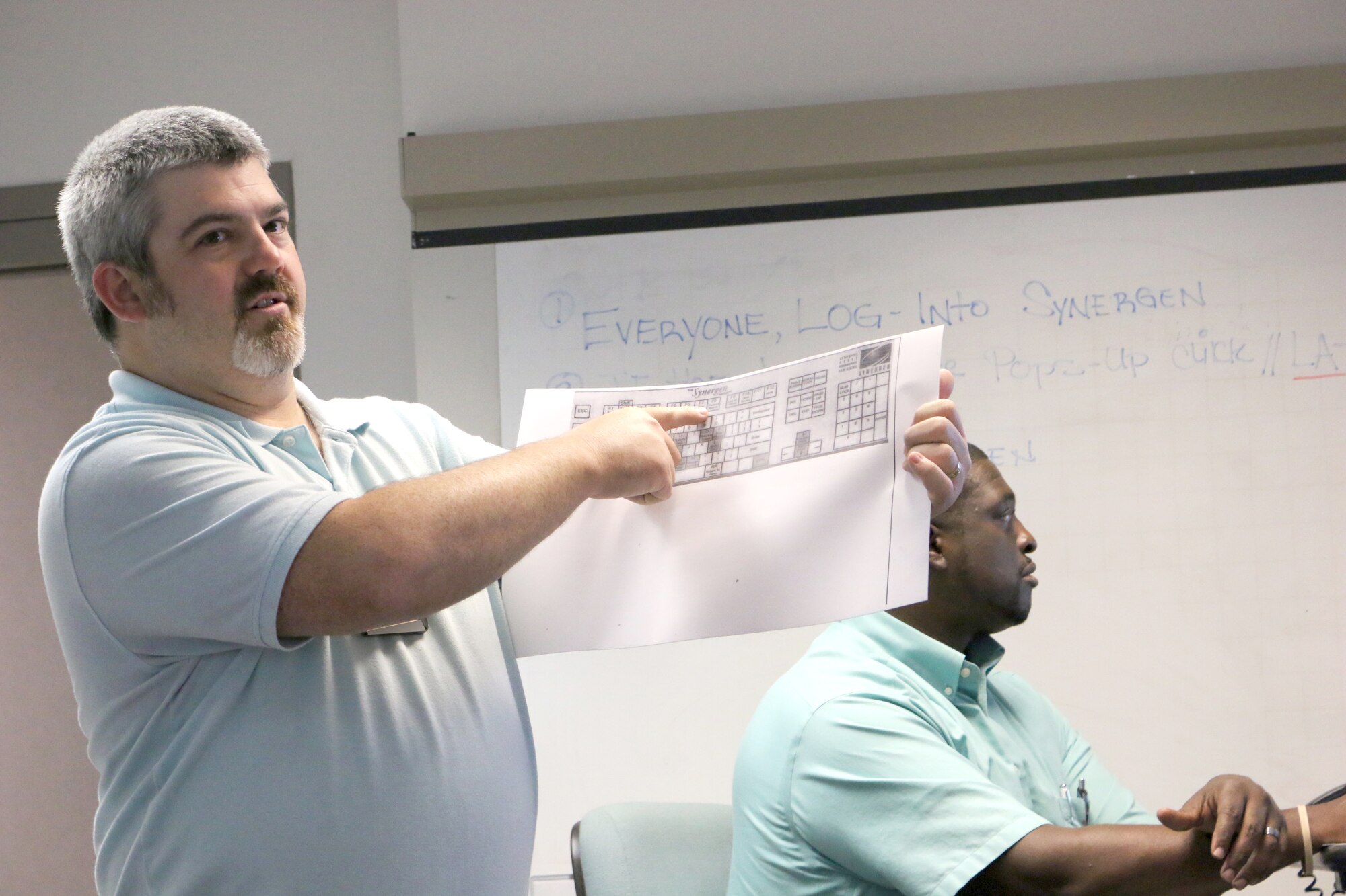 Test Operations Engineer and Ground Test University instructor Bernie Williamson discusses Synergen system hot keys during a recent GTU class. Also pictured is fellow GTU instructor Julius Lockett, a systems engineer in the Engine Test Facility. The purpose of GTU is to provide younger members of the AEDC workforce and their more-tenured counterparts in new positions with knowledge and information to help them more effectively complete job tasks. (U.S. Air Force photo by Bradley Hicks) (This image was manipulated by obscuring badges for security purposes)