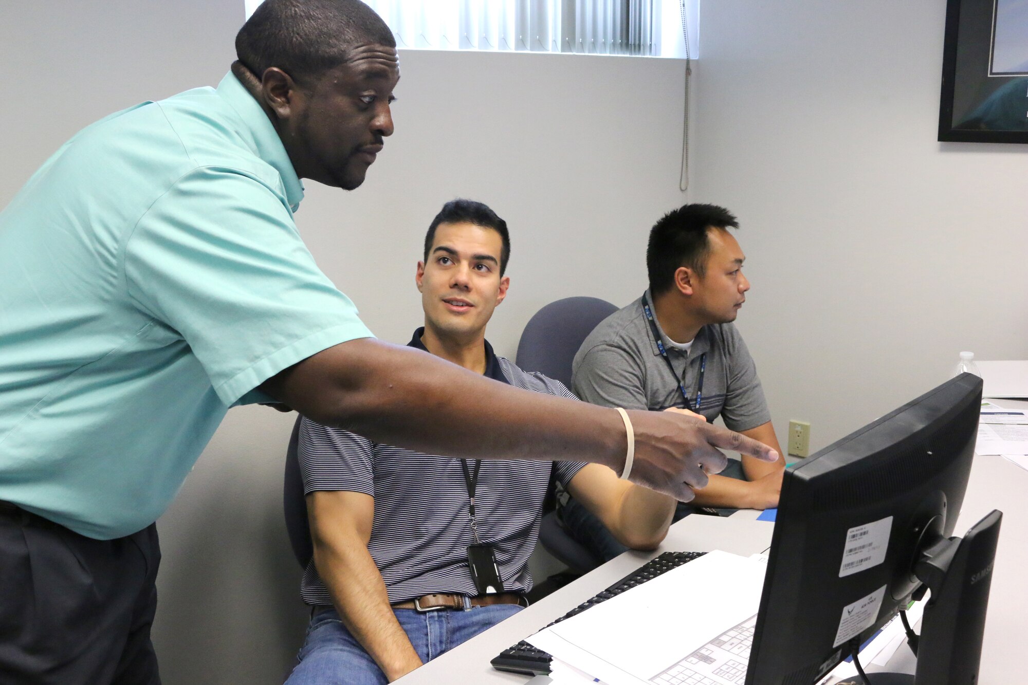 Julius Lockett, a systems engineer in the Engine Test Facility, left, answers a question from engineer Aaron Smith during a recent Ground Test University class. Also pictured is engineer Hakita Khampakasy. The purpose of GTU is to provide younger members of the AEDC workforce and their more-tenured counterparts in new positions with knowledge and information to help them more effectively complete job tasks. (U.S. Air Force photo/Bradley Hicks)