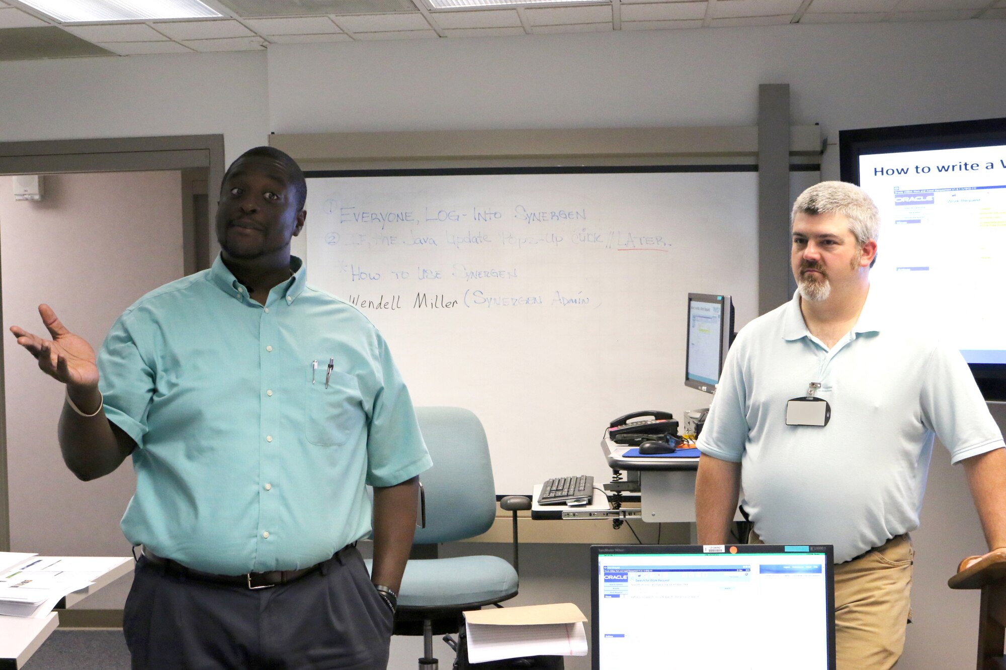 Ground Test University instructors and AEDC engineers Julius Lockett, left, and Bernie Williamson lead a GTU class. The purpose of GTU is to provide younger members of the AEDC workforce and their more-tenured counterparts in new positions with knowledge and information to help them more effectively complete job tasks. (U.S. Air Force photo by Bradley Hicks) (This image was manipulated by obscuring badges for security purposes)