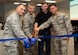 Col. Darren Buck, 310th Space Wing vice commander, Col. Stephen Slade, 310th Operations Group commander, Lt. Col. Timothy Gasmire (retired) and Airman 1st Class Reinhart Medina cut a ribbon during the reveal of an updated operations floor for the 6th Space Operations Squadron Aug. 4th, 2018.