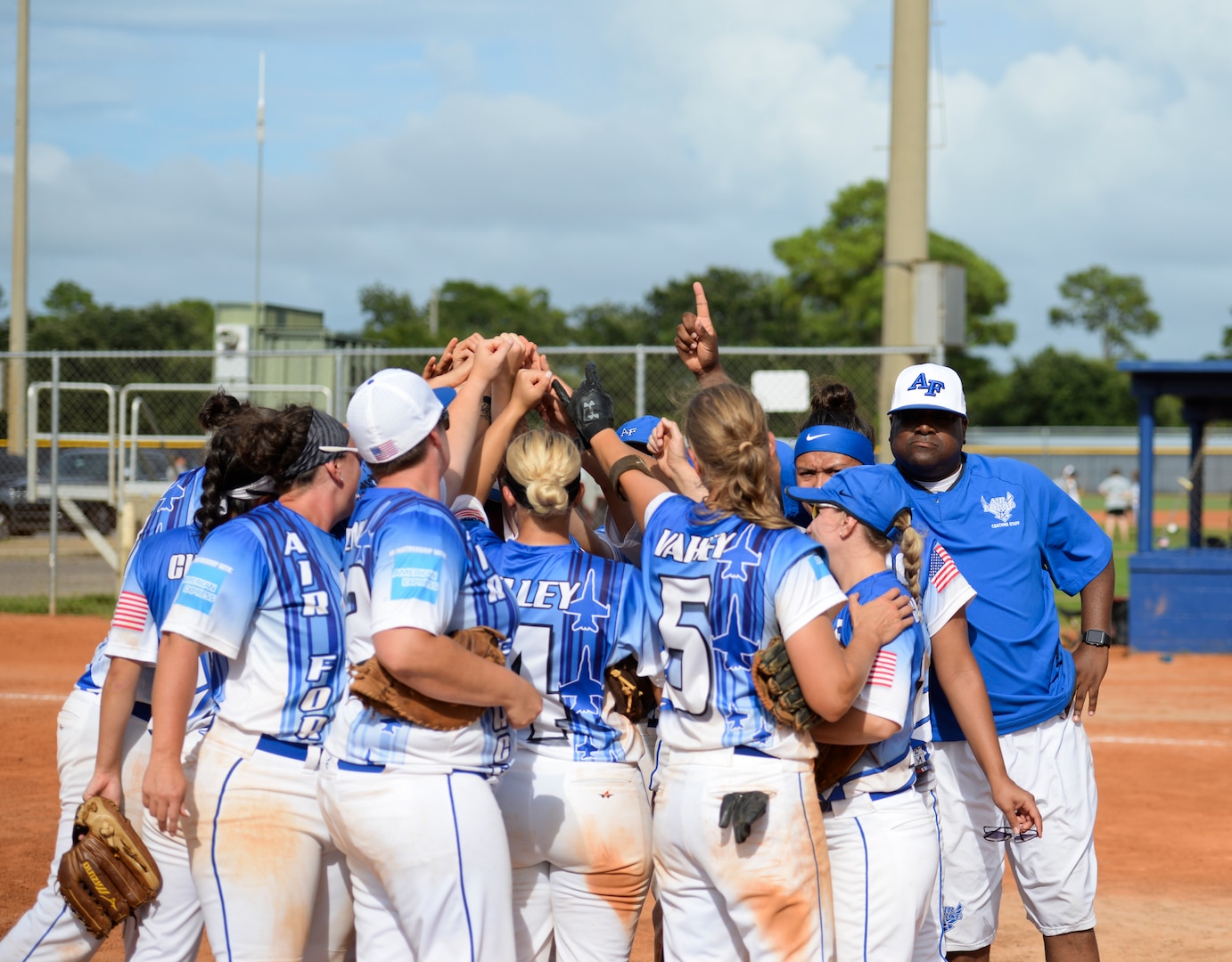 PENSACOLA, Fla.-- The All Air Force team huddles for a team-high five after winning gold for the second year running during the 2018 Women's Armed Forces Softball Championship, Aug. 15-17. Teams from the Navy, Army and Marine Corps look to dethrone the defending champion Air Force team. (U.S. Navy photo by Mass Communication Specialist 2nd Class Timothy A. Hazel/Released)