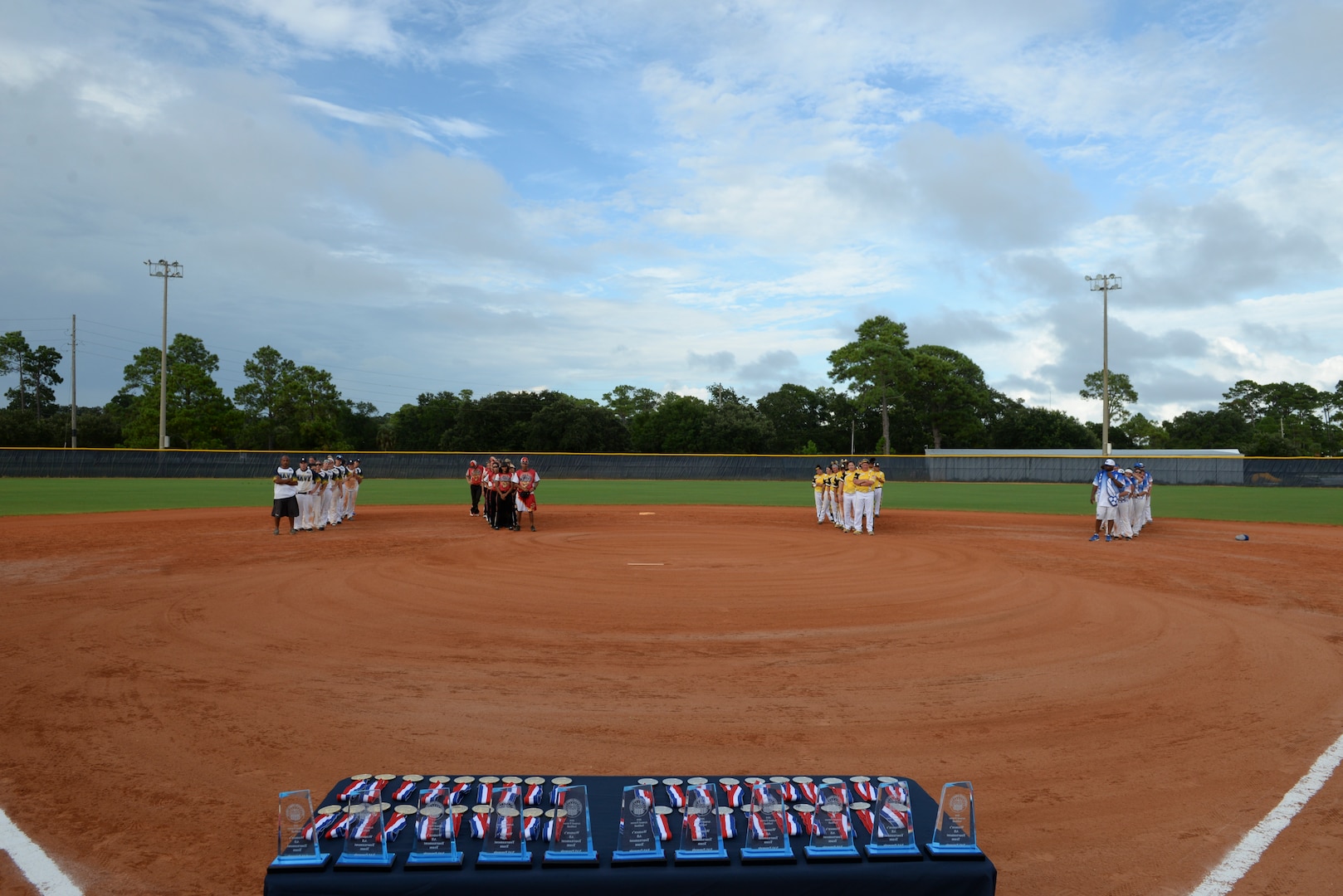 PENSACOLA, Fla.-- Teams gather for the closing ceremonies of the 2018 Women's Armed Forces Softball Championship, Aug. 15-17. Teams from the Navy, Army and Marine Corps tried to dethrone the defending champion Air Force team, but the Air Force ladies win gold for a second year(. (U.S. Navy photo by Mass Communication Specialist 2nd Class Timothy A. Hazel/Released)