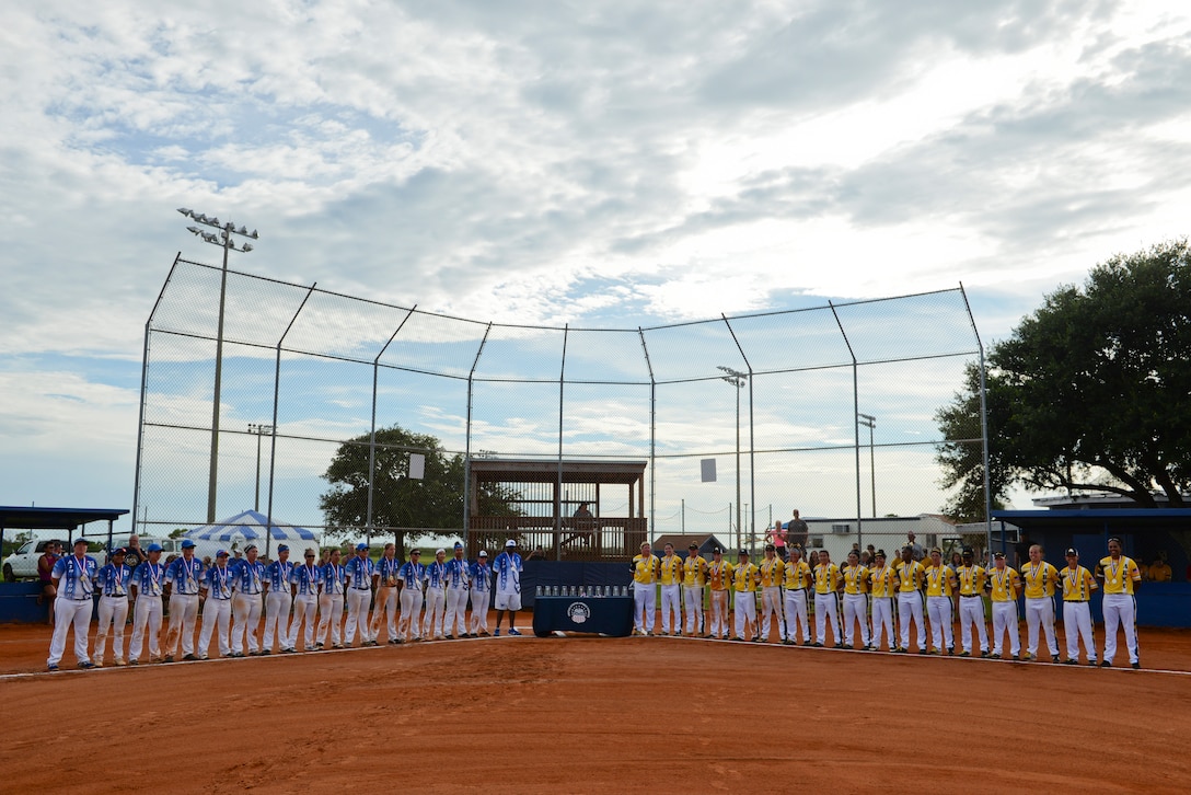 PENSACOLA, Fla. -- The All-Air Force and All-Army teams stand during the closing ceremonies for the 2018 Women's Armed Forces Softball Championship, Aug. 15-17. The Air Force team took gold for the second straight year, and the Army took silver. (U.S. Navy photo by Mass Communication Specialist 2nd Class Timothy A. Hazel/Released)