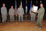 U.S. Navy Vice Admiral David M. Kriete, deputy commander of the U.S. Strategic Command (USSTRATCOM) present a trophy during a luncheon and ceremony at the Patriot Club on Offutt Air Force Base, Neb., Aug. 6, 2018. The 251st Cyberspace Engineering Installation Group, the 220th Engineering Installation Squadron, and the total force, United States Air Force engineering installation community were recognized for providing the infrastructure and cable installation for the new USSTRATCOM Command and Control facility over the past five years. (USSTRATCOM photo by Steve Cunningham)