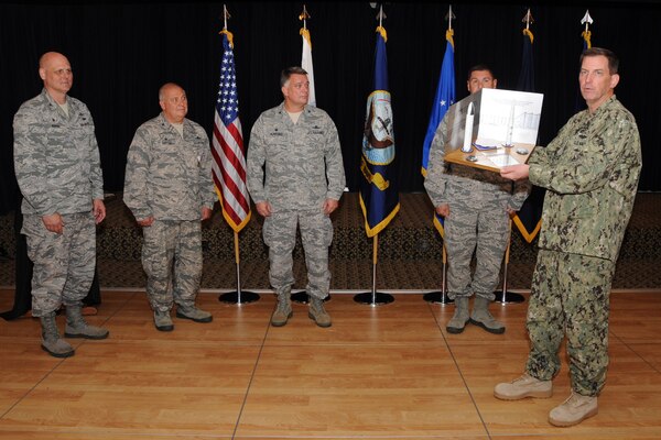 U.S. Navy Vice Admiral David M. Kriete, deputy commander of the U.S. Strategic Command (USSTRATCOM) present a trophy during a luncheon and ceremony at the Patriot Club on Offutt Air Force Base, Neb., Aug. 6, 2018. The 251st Cyberspace Engineering Installation Group, the 220th Engineering Installation Squadron, and the total force, United States Air Force engineering installation community were recognized for providing the infrastructure and cable installation for the new USSTRATCOM Command and Control facility over the past five years. (USSTRATCOM photo by Steve Cunningham)