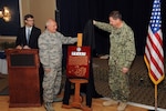 U.S. Navy Vice Admiral David M. Kriete, deputy commander of the U.S. Strategic Command (USSTRATCOM), and U.S. Air Force Col. Wade Rupper, commander of the 251st Cyberspace Engineering Installation Group (251st CEIG), present a plaque during a luncheon and ceremony at the Patriot Club on Offutt Air Force Base, Neb., Aug. 6, 2018. The 251st CEIG, the 220th Engineering Installation Squadron, and the total force, United States Air Force engineering installation community were recognized for providing the infrastructure and cable installation for the new USSTRATCOM Command and Control facility over the past five years.