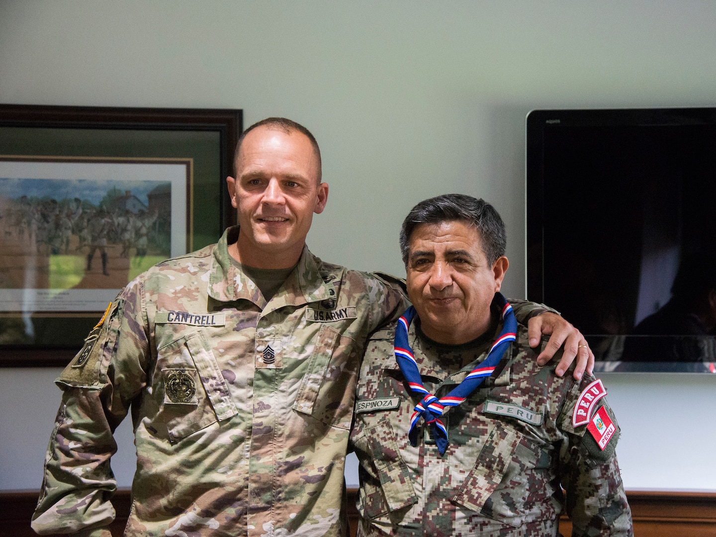 West Virginia Army National Guard Command Sgt. Maj. Phillip Cantrell poses for a photo with Técnico Jefe Superior Pedro Espinoza, sergeant major of the Peruvian army Aug. 16, 2018, at the West Virginia National Guard Joint Force Headquarters in Charleston, West Virginia.