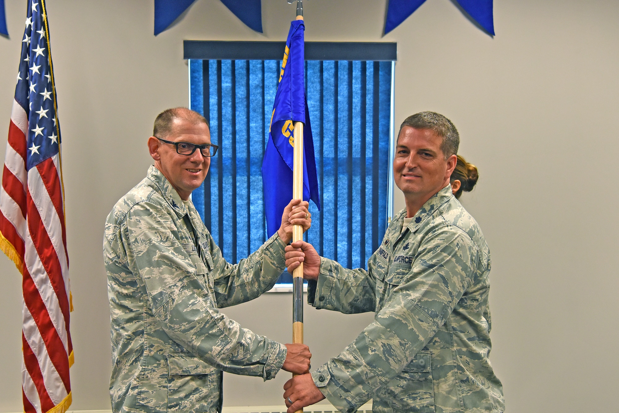 Lt. Col. Chad Manifold, right, accepts the guideon from 911th Mission Support Group Commander Col. Kenneth Lute during an assumption of command ceremony at the Pittsburgh International Airport Air Reserve Station, Pennsylvania, Aug. 4, 2018. During this ceremony, Manifold formally became commander of the 911th Communications Squadron. (U.S. Air Force photo by Staff Sgt. Marjorie A. Bowlden)