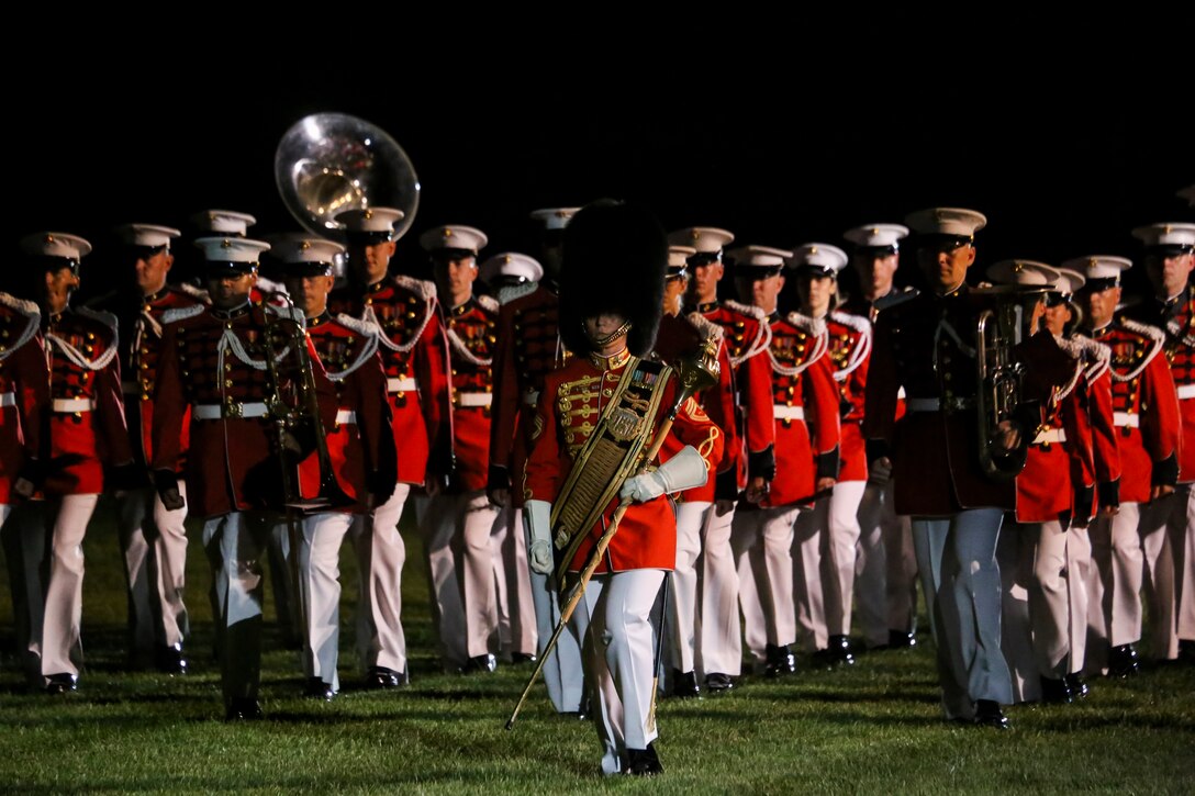 Gunnery Sgt. Stacie Crowther, assistant drum major, “The President’s Own” U.S. Marine Band marches the band across the parade deck during a Friday Evening Parade at Marine Barracks Washington D.C., Aug. 17, 2018. The guest of honor for the parade was the Honorable James F. Geurts, assistant secretary of the Navy for Research, Development and Acquisition and the hosting official was Lt. Gen. Michael G. Dana, director, Marine Corps Staff. (Official Marine Corps photo by Sgt. Robert Knapp/Released)