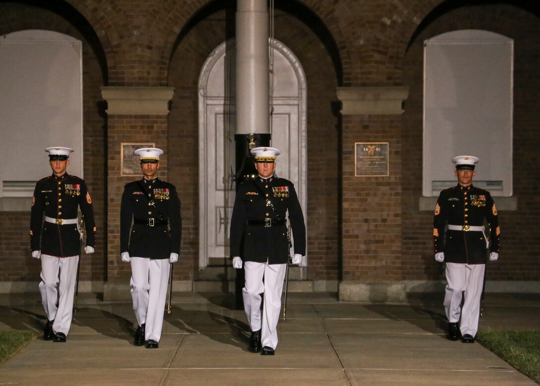 Marines with the Marine Barracks Washington D.C. parade marching staff march down Center Walk during a Friday Evening Parade at the Barracks, Aug. 17, 2018.