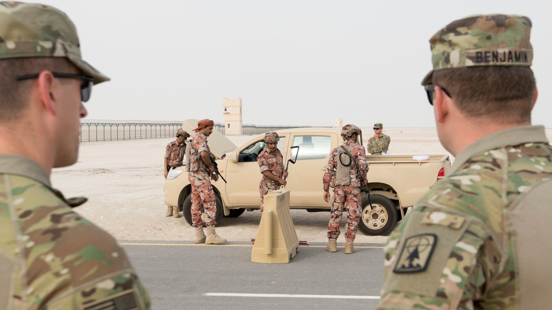 U.S. Army Soldiers with the 157th Military Engagement Team, Wisconsin Army National Guard, attached to U.S. Army Central, observe soldiers from the Royal Army of Oman's Border Guard Brigade performing a vehicle search as part of a practical exercise in which soldiers from each country demonstrated their preferred method of operating a vehicle control point in Haima, Oman, Aug. 8, 2018. The collaborative exercise increased interoperability between the U.S. Army and Omani Army by creating an opportunity for soldiers from each country to share best practices in border security. (U.S. Army photo by Spc. Adam Parent)