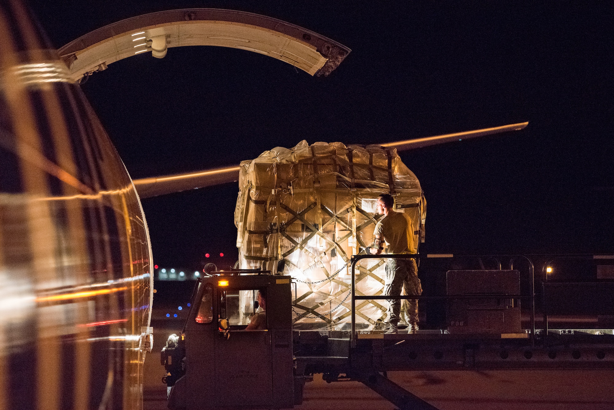 Team Dover Airmen with the 436th Aerial Port Squadron load pallets onto a commercial cargo aircraft Aug. 2, 2018, at Dover Air Force Base, Del. Blood shipments arrive via truck from the Armed Services Whole Blood Processing Laboratory East at Joint Base McGuire-Dix-Lakehurst and are typically airborne on an aircraft within two to six hours.