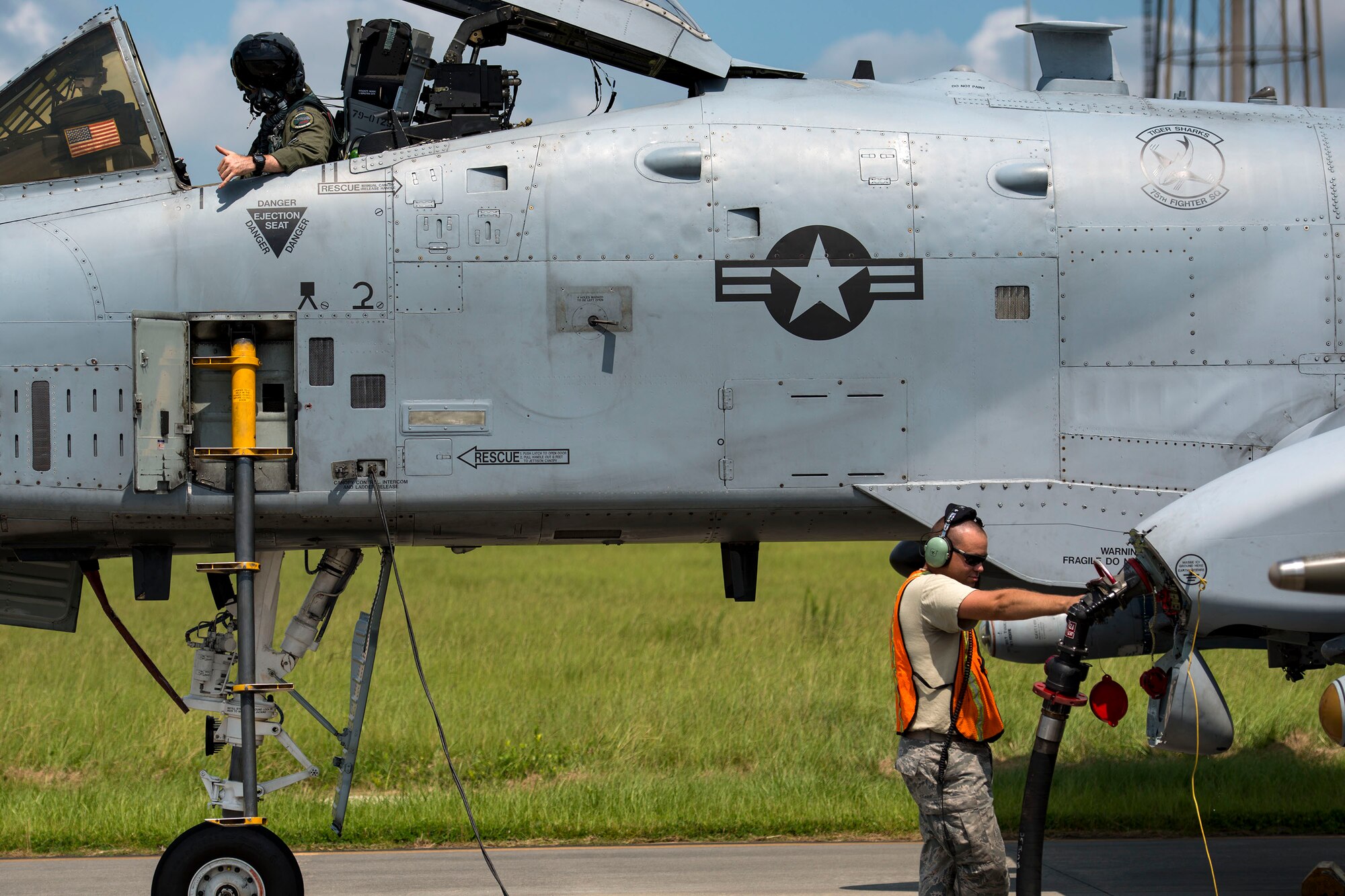 Staff Sgt. Jared Burrus, right, 476th Maintenance Squadron crew chief, flips fuel flow switches on an A-10C Thunderbolt II during a hot pit refueling, Aug. 14, 2018, at Moody Air Force Base, Ga. Members of the 23d Logistics Readiness Squadron preposition fueling trucks to allow aircraft to refuel without needing to shut down. This style of refueling is used to eliminate the need for additional maintenance procedures and to extend pilots’ training time per flight which improves operations tempo. (U.S. Air Force photo by Airman 1st Class Erick Requadt)