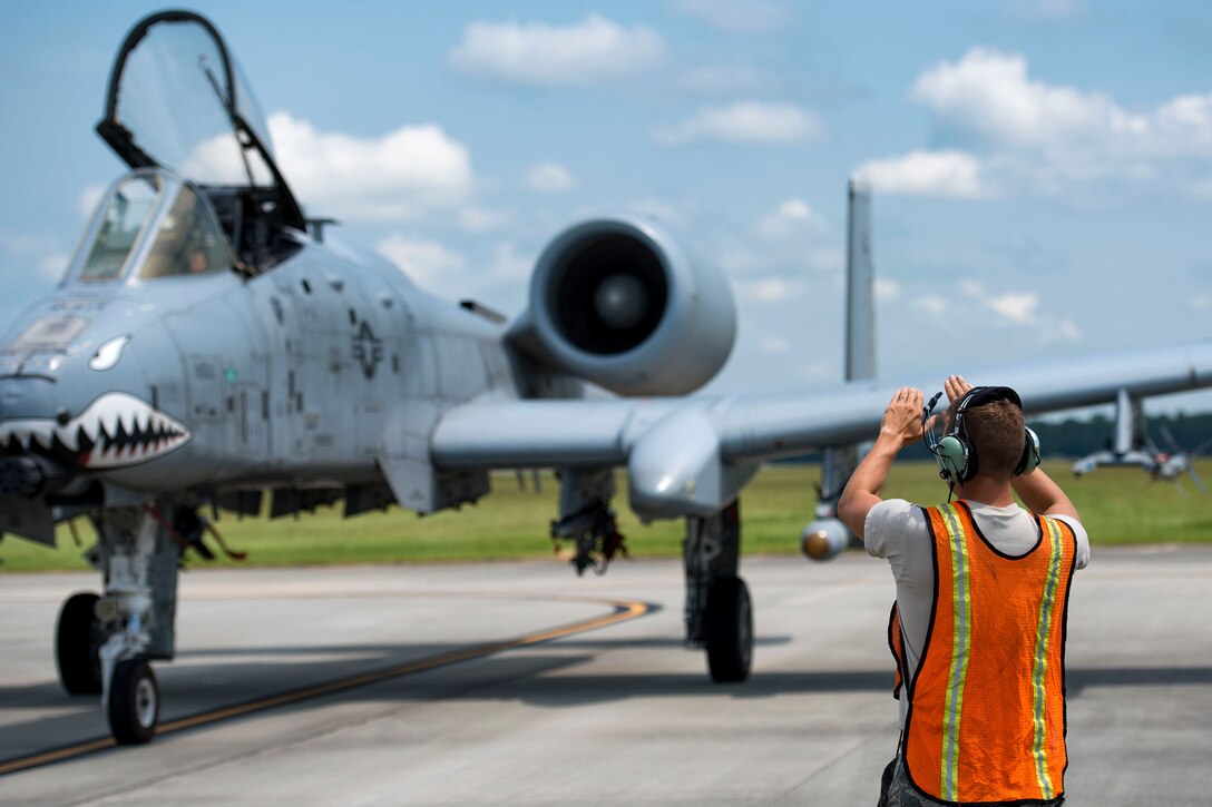 Tech. Sgt. Brandon Hoke, 476th Maintenance Squadron crew chief, marshals an A-10C Thunderbolt II, Aug. 14, 2018, at Moody Air Force Base, Ga. Members of the 23d Logistics Readiness Squadron preposition fueling trucks to allow aircraft to refuel without needing to shut down. This style of refueling is used to eliminate the need for additional maintenance procedures and to extend pilots’ training time per flight which improves operations tempo. (U.S. Air Force photo by Airman 1st Class Erick Requadt)