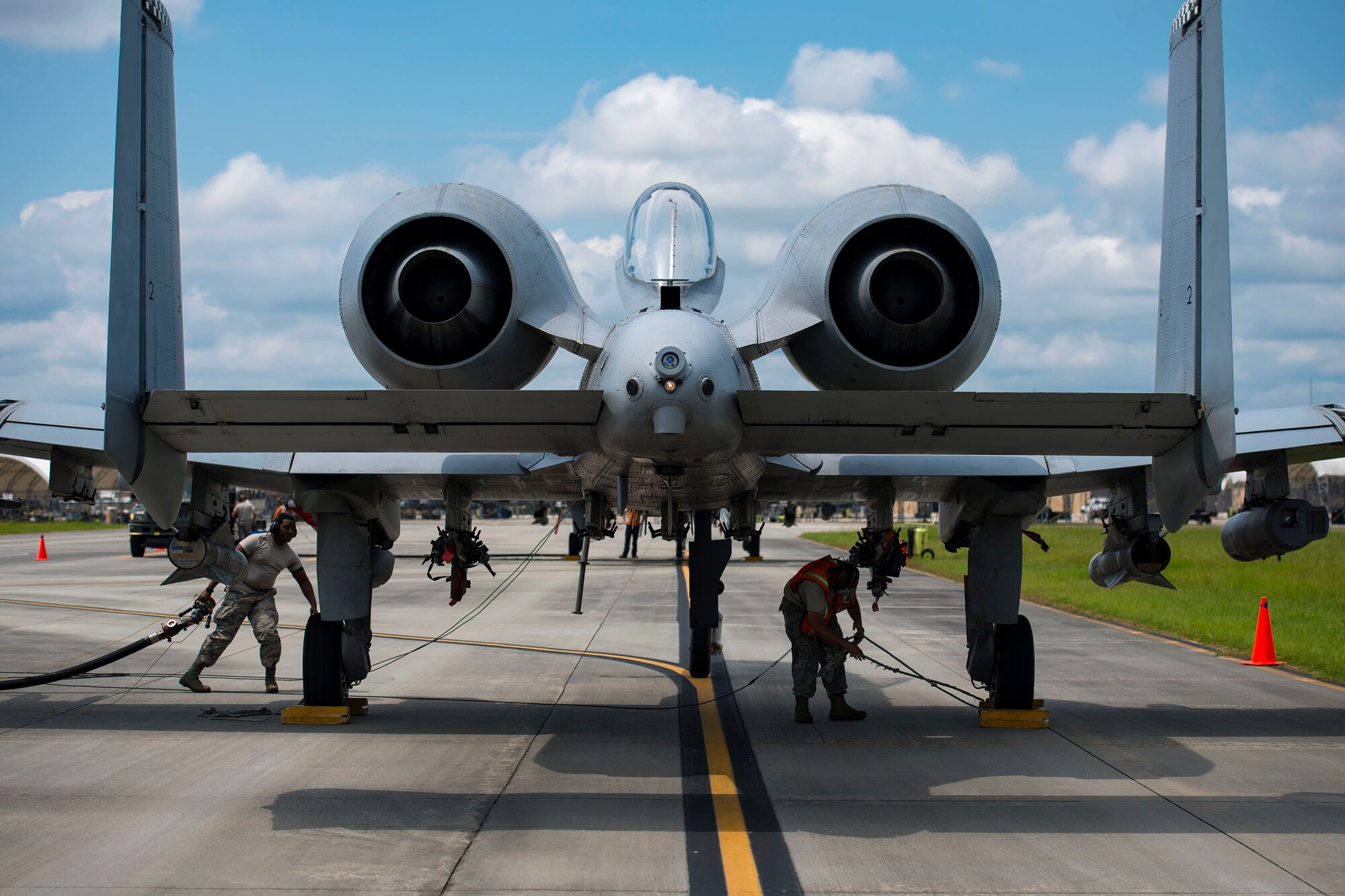 Airmen from the 23d Logistic Readiness Squadron (LRS) and 476th Maintenance Squadron gear up to hot pit refuel an A-10C Thunderbolt II, Aug. 14, 2018, at Moody Air Force Base, Ga. Members of the 23d LRS preposition fueling trucks to allow aircraft to refuel without needing to shut down. This style of refueling is used to eliminate the need for additional maintenance procedures and to extend pilots’ training time per flight which improves operations tempo. (U.S. Air Force photo by Airman 1st Class Erick Requadt)