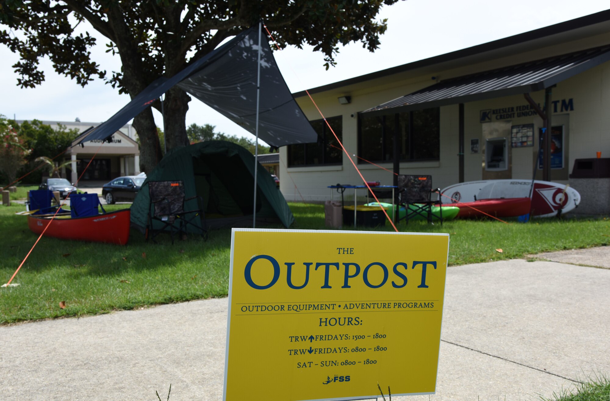 A sign for The Outpost is displayed during the grand opening at the Vandenberg Commons at Keesler Air Force Base, Mississippi, Aug. 17, 2018. The Outpost is a satellite store from the Outdoor Recreation Center with recreation items available for Airmen in the 81st Training Group. (U.S. Air Force photo by Kemberly Groue)