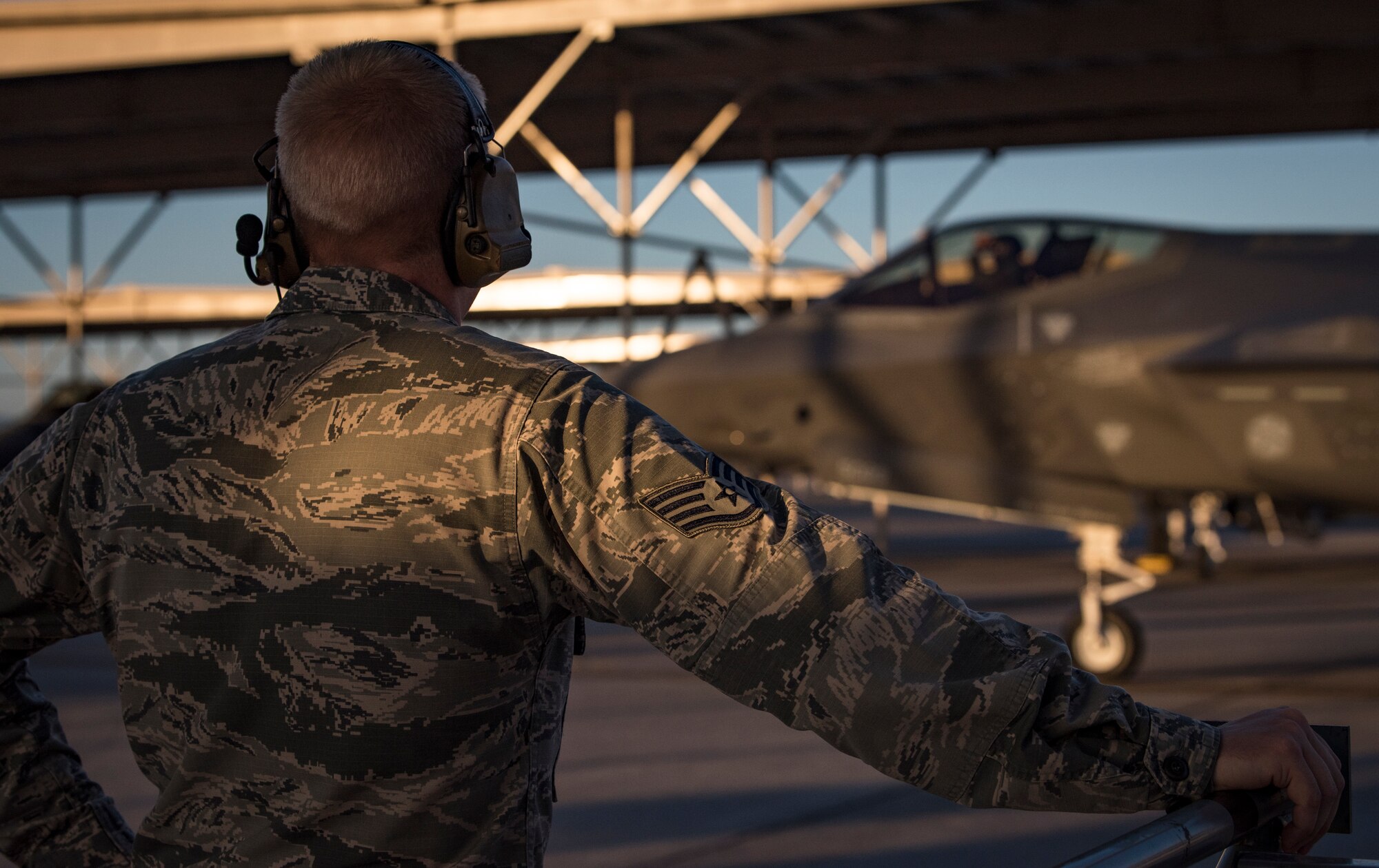 Staff Sgt. Joshua Harris, 57th Aircraft Maintenance Squadron Lightning Aircraft Maintenance Unit activity security manager, observes an F-35A Lightning II fighter jet taxi to the runway at Nellis Air Force Base, Nevada, July 23, 2018. Harris previously worked on A-10 Thunderbolt II close air support aircraft before transitioning to the F-35A. (U.S. Air Force photo by Airman 1st Class Andrew D. Sarver)