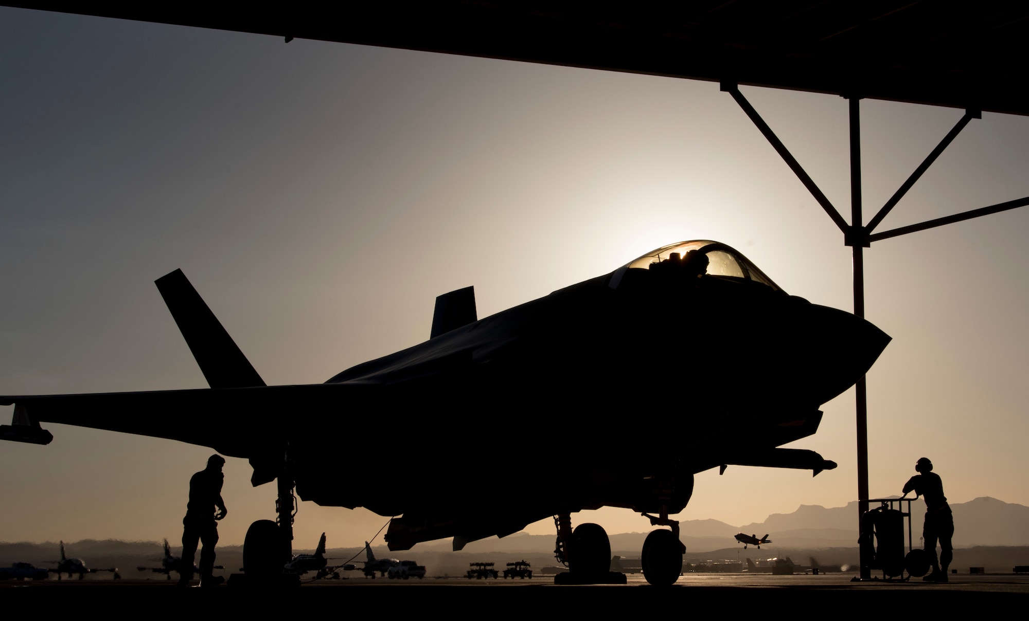 Airmen 1st Class Zachary Cray and Chayce Ardoin, 57th Aircraft Maintenance Squadron Lightning Aircraft Maintenance Unit crew chiefs, perform pre-flight checks at Nellis Air Force Base, Nevada, July 23, 2018. Crew chiefs are responsible for the maintenance, launch and recovery of the aircraft. (U.S. Air Force photo by Airman 1st Class Andrew D. Sarver)