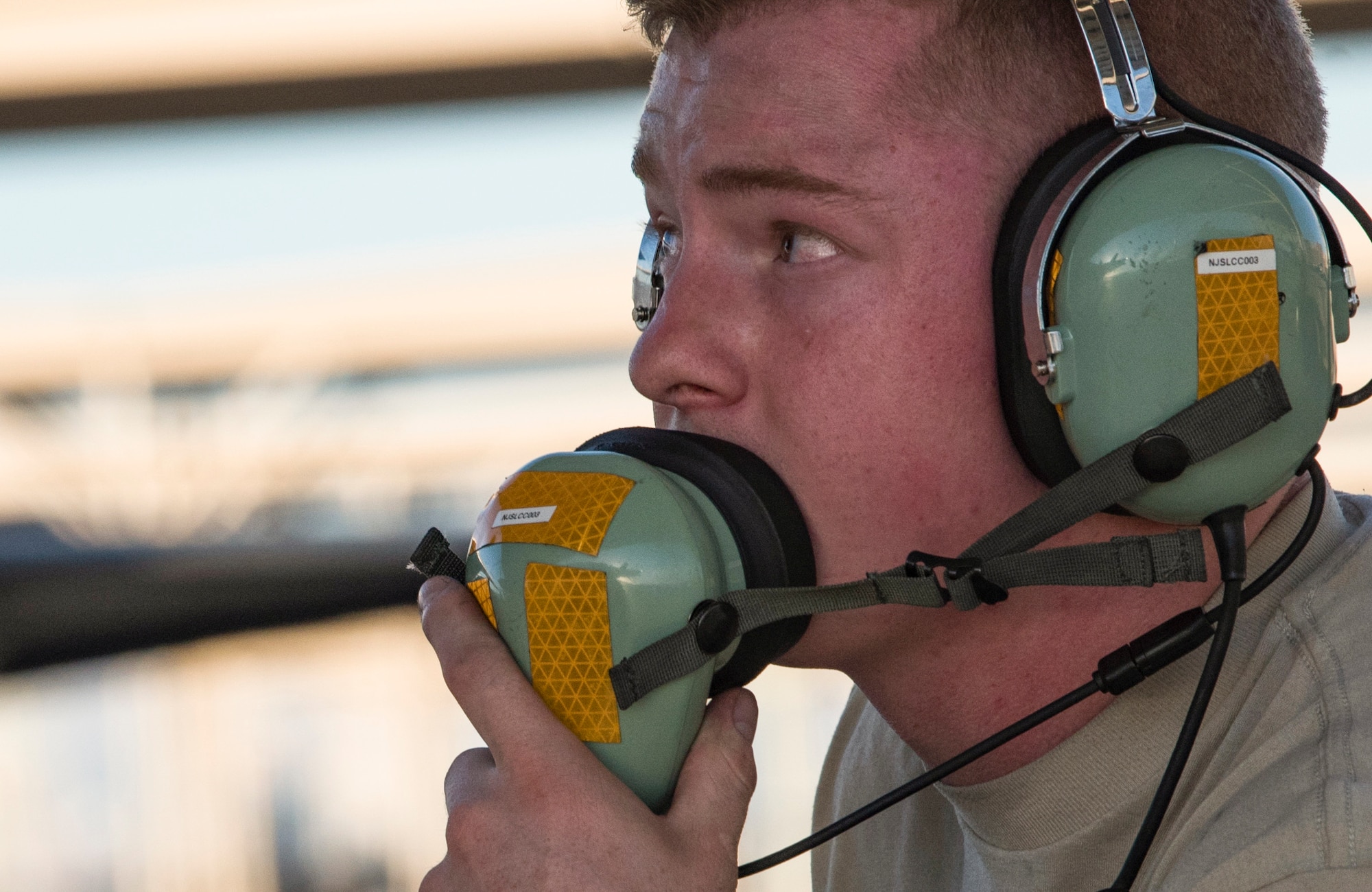 Airman 1st Class Chayce Ardoin, 57th Aircraft Maintenance Squadron Lightning Aircraft Maintenance Unit crew chief, talks into his headset at Nellis Air Force Base, Nevada, July 23, 2018. Crew chiefs use headsets to communicate to each other and the pilot, during pre- and post-flight checks. (U.S. Air Force photo by Airman 1st Class Andrew D. Sarver)