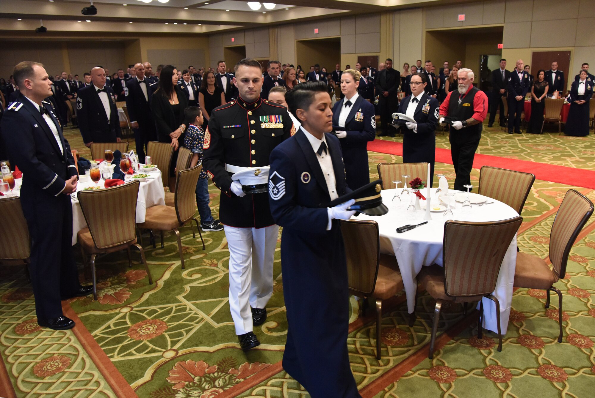 Military and civilian service members participate in a POW/MIA table ceremony during the Senior NCO Induction Ceremony at the Bay Breeze Event Center at Keesler Air Force Base, Mississippi, Aug. 17, 2018. More than 50 inductees were recognized during the event. A medallion ceremony and a candle lighting ceremony also took place during the event. (U.S. Air Force photo by Kemberly Groue)