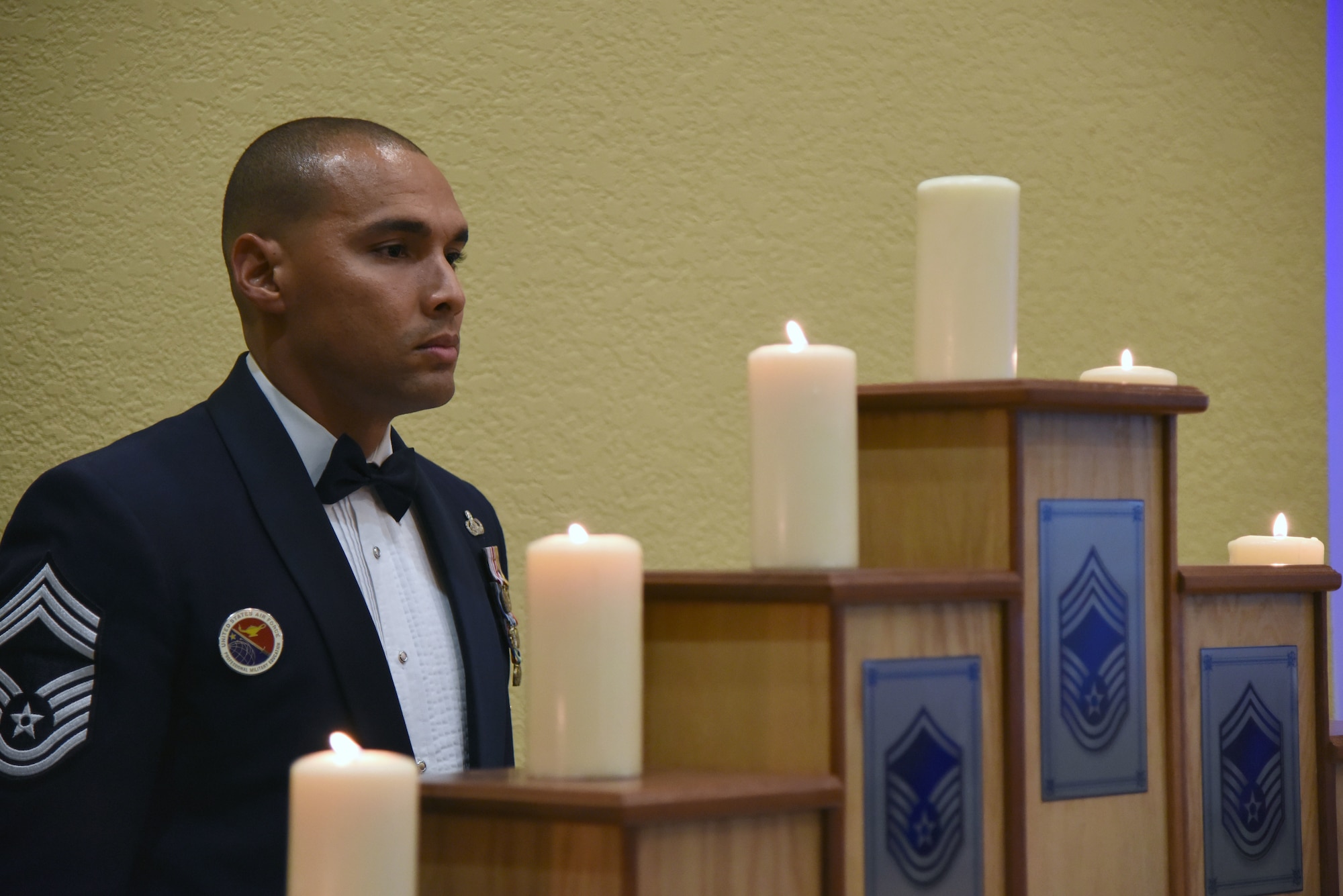 U.S. Air Force Chief Master Sgt. Rodney Deese, II, Mathies NCO Academy commandant, participates in the candle lighting ceremony during the Senior NCO Induction Ceremony at the Bay Breeze Event Center at Keesler Air Force Base, Mississippi, Aug. 17, 2018. More than 50 inductees were recognized during the event. (U.S. Air Force photo by Kemberly Groue)