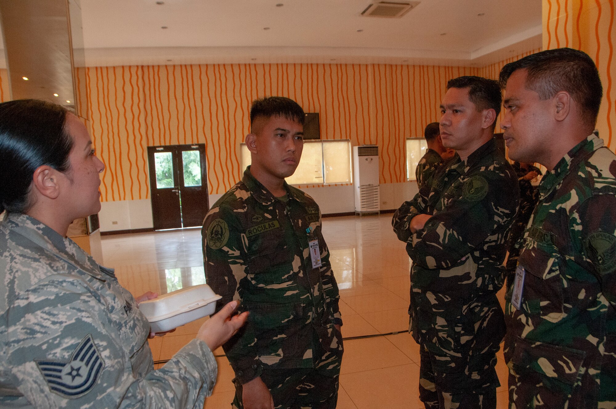 Tech. Sgt. Franchesa Pau’u, 169th Air Defense Squadron weapons controller talks with a group of Philippine Air Force airmen