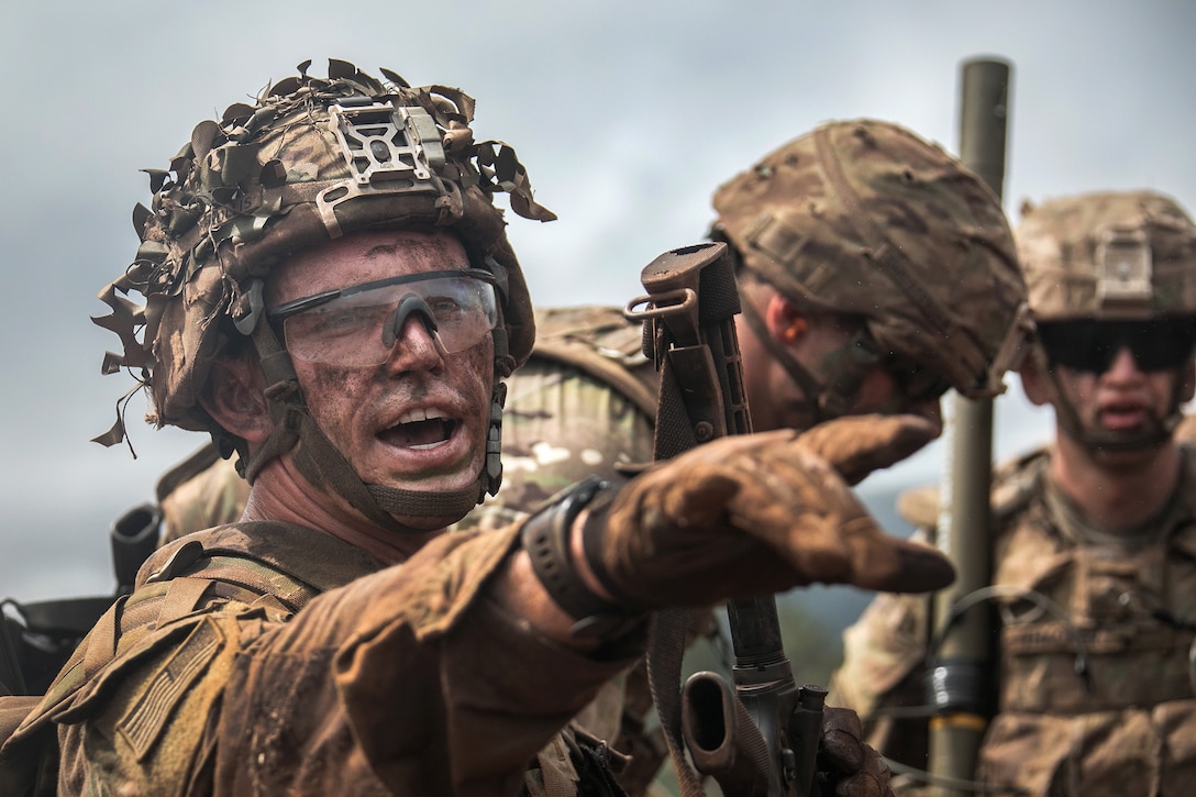 A soldier yells out a follow-on order during a combined arms live-fire exercise.