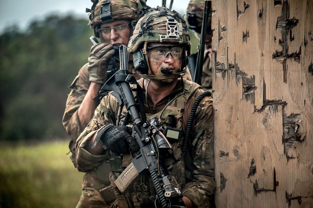 Soldiers prepare to clear a building during a combined arms live-fire exercise.