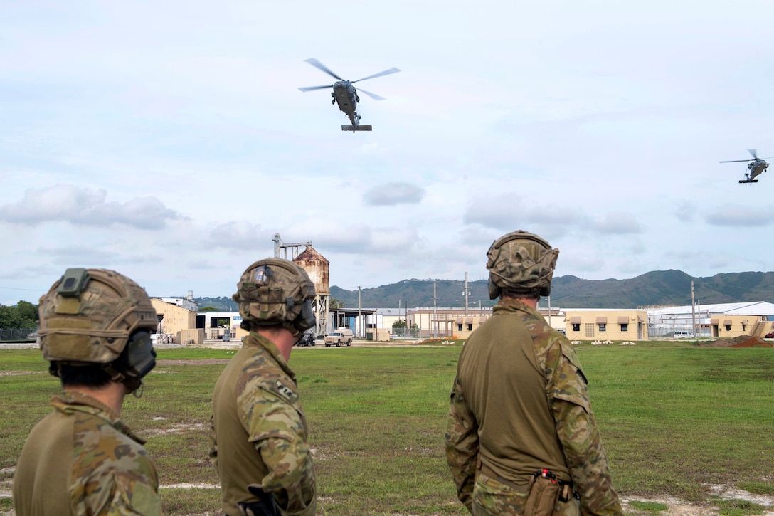 Australian soldiers prepare to fast-rope from U.S. Navy MH-60S Seahawk helicopters.