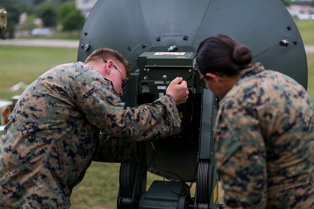 Marines with Marine Aircraft Group 13 work on communications equipment during Exercise Northern Lightning at Volk Field Counterland Training Center, Camp Douglas, Wis. Aug. 16. Exercise Northern Lightning 2018 allows the Air Force, Marine Corps and Navy to strengthen interoperability between services and gives the different branches a greater understanding of aviation capabilities within a joint fighting force.