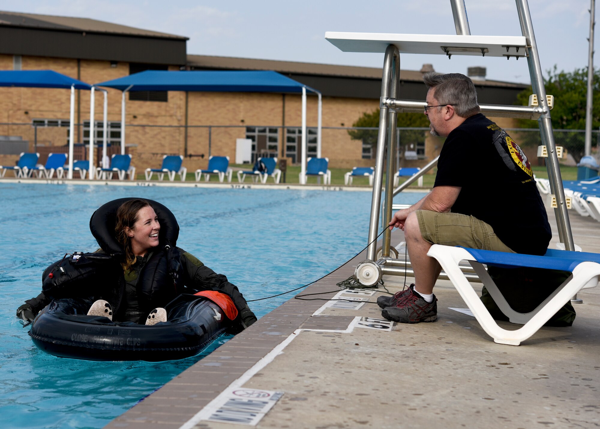 An airman smiles as she relaxes on a water raft after just completing the water survival emergency training at Sheppard Air Force Base.