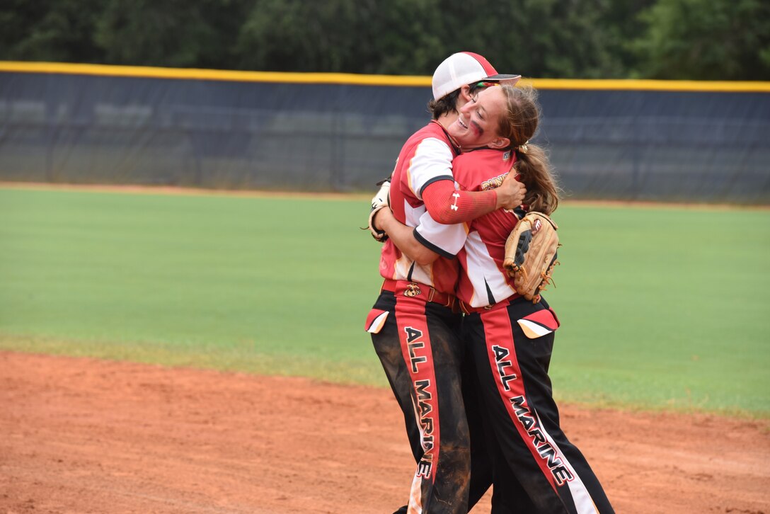 PENSACOLA, Fla. – Marine Sgt. Katie Dunkelberger celebrates with her teammate, Sgt. Michele Cox, during the third round of the 2018 Armed Forces Women's Softball Championship, Aug. 17. Teams from the Navy, Army, Air Force and Marine Corps competed to determine a military women's softball champion. (U.S. Navy photo by Mass Communication Specialist 1st Class Christopher Hurd/Released)