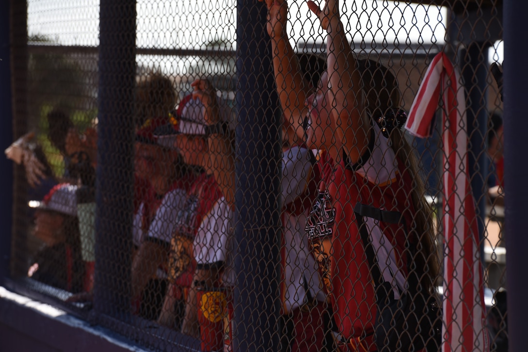 PENSACOLA, Fla. -- Marine Sgt. Katie Dunkelberger cheers on her All-Marine softball teammates during the opening game of the 2018 Armed Forces Women's Softball Championship, Aug. 15. Teams from the Navy, Army, Air Force and Marine Corps competed to determine a military women's softball champion. (U.S. Navy photo by Mass Communication Specialist 1st Class Christopher Hurd/Released)