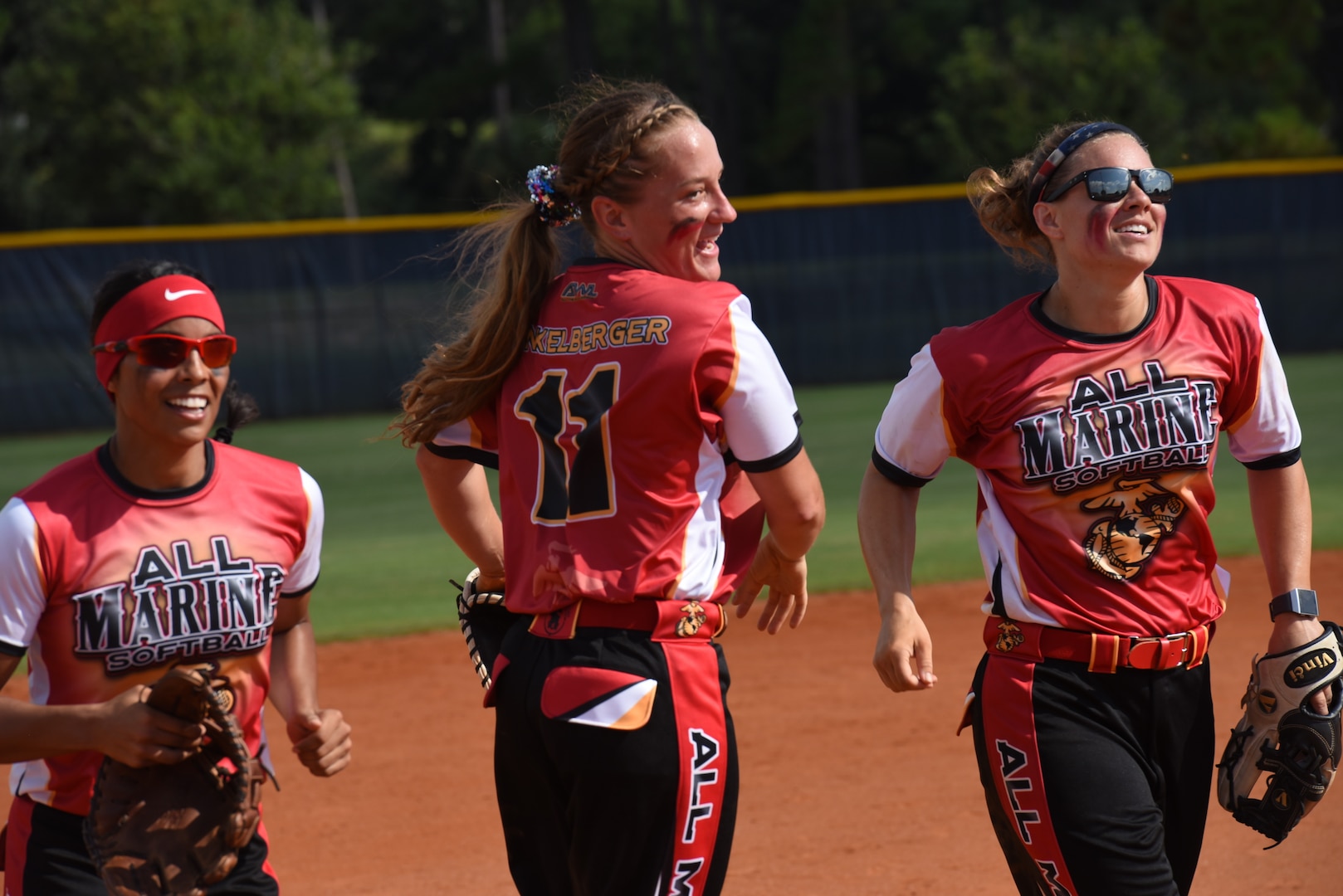 PENSACOLA, Fla. – Marine Sgt. Katie Dunkelberger celebrates with her All-Marine softball teammates during the opening game of the 2018 Armed Forces Women's Softball Championship, Aug. 15.Teams from the Navy, Army, Air Force and Marine Corps competed to determine a military women's softball champion. (U.S. Navy photo by Mass Communication Specialist 1st Class Christopher Hurd/Released)