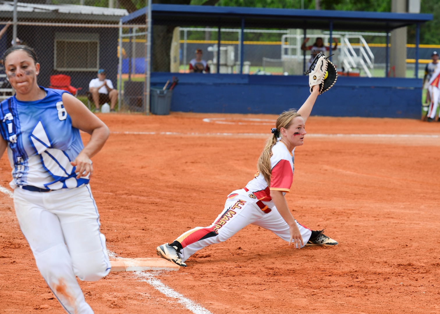 PENSACOLA, Fla. – Marine Sgt. Katie Dunkelberger stretches to get the out during a second-round game of the 2018 Armed Forces Women's Softball Championship, Aug. 16. Teams from the Navy, Army,  Air Force and Marine Corps competed in a three-day tournament to determine a military softball champion. (U.S. Navy photo by Mass Communication Specialist 2nd Class Timothy A. Hazel/Released)