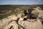 Sniper team fires at long-range targets.