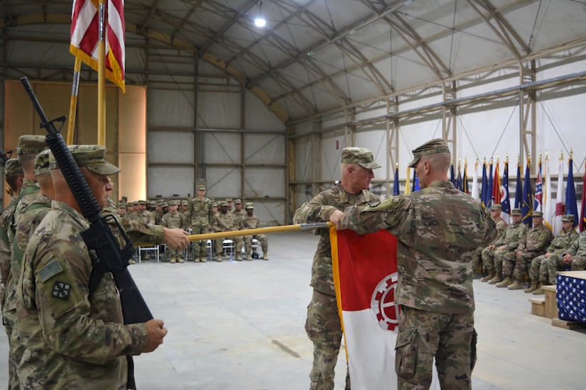 Col. Anthony Adrian (right) and Command Sgt. Maj. Steven Stuenkel, 35th Engineer Brigade commander and command sergeant major, respectively, case the brigade’s colors during a transfer of authority ceremony Aug. 16, 2018. The brigade, part of the Missouri Army National Guard, is concluding a nine-month deployment to the Middle East.