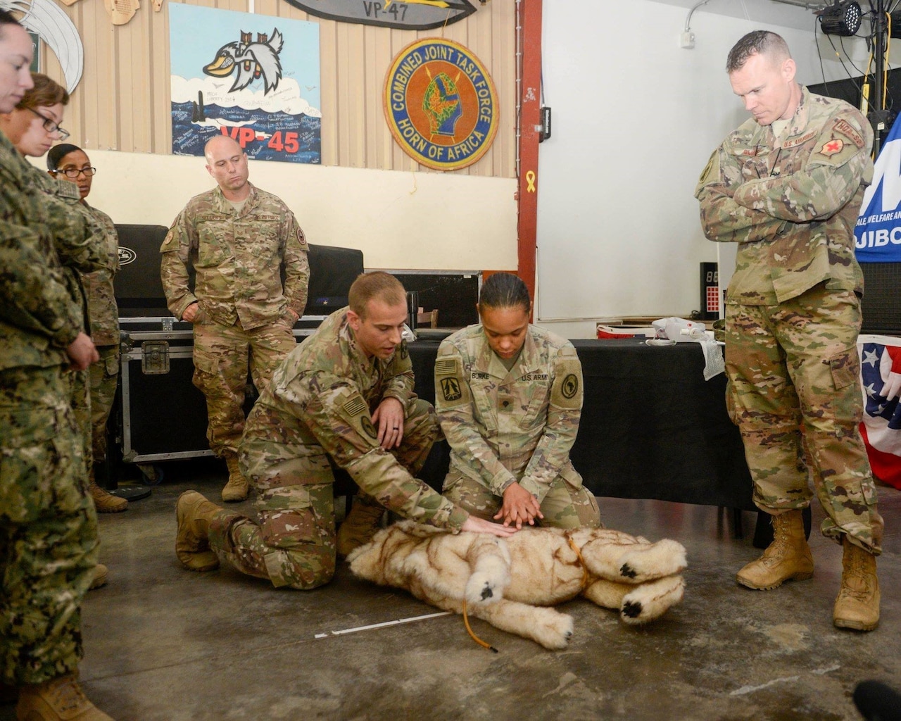 Service members take part in canine casualty care training.