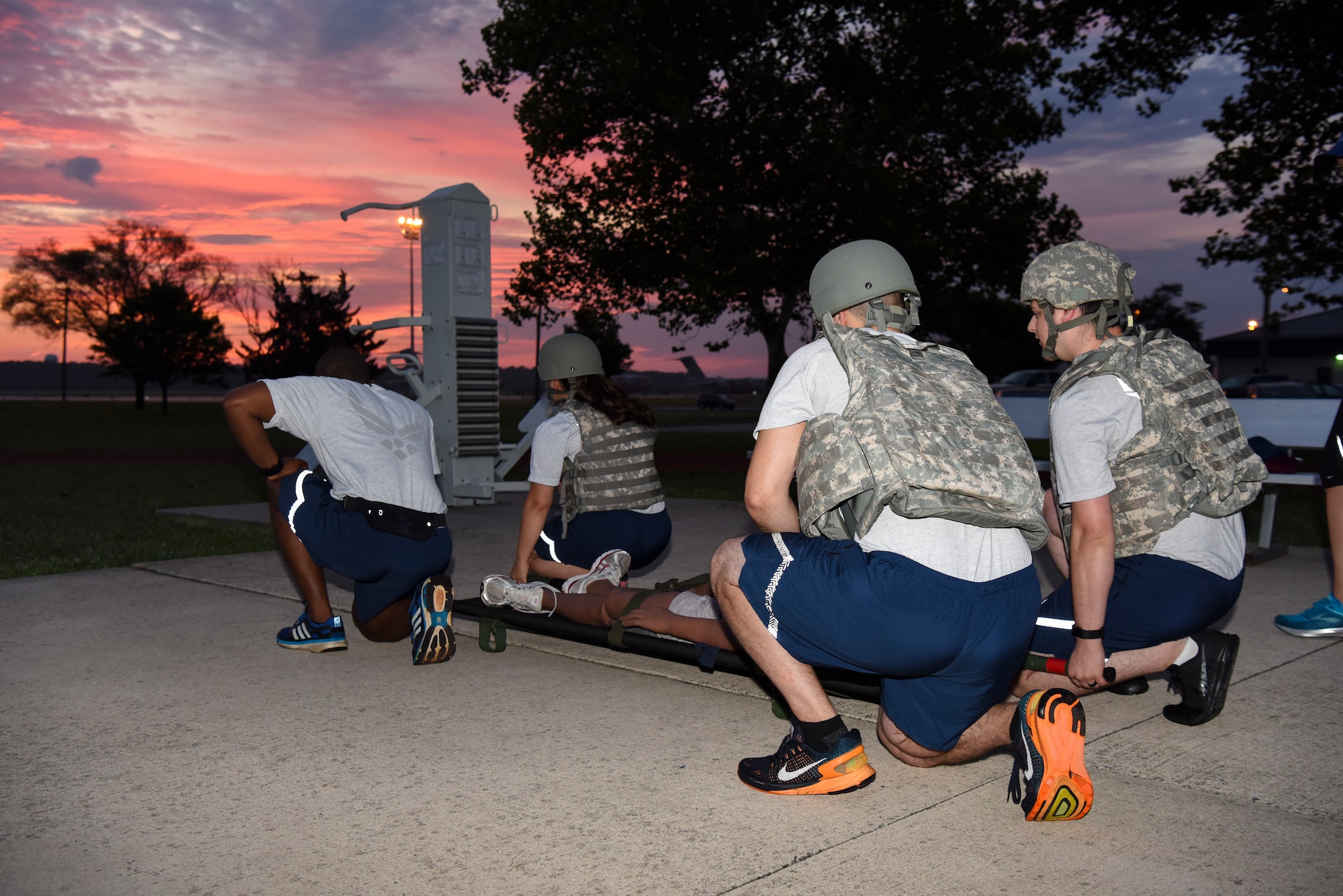 Medics assigned to the 436th Medical Group prepare to lift a litter supporting a training dummy July 30, 2018, at Dover Air Force Base, Del. A team of four Dover medics travelled to Cannon AFB and Melrose Air Force Range, N.M., to compete in the annual Emergency Medical Technician Rodeo. (U.S. Air Force photo by Staff Sgt. Aaron J. Jenne)