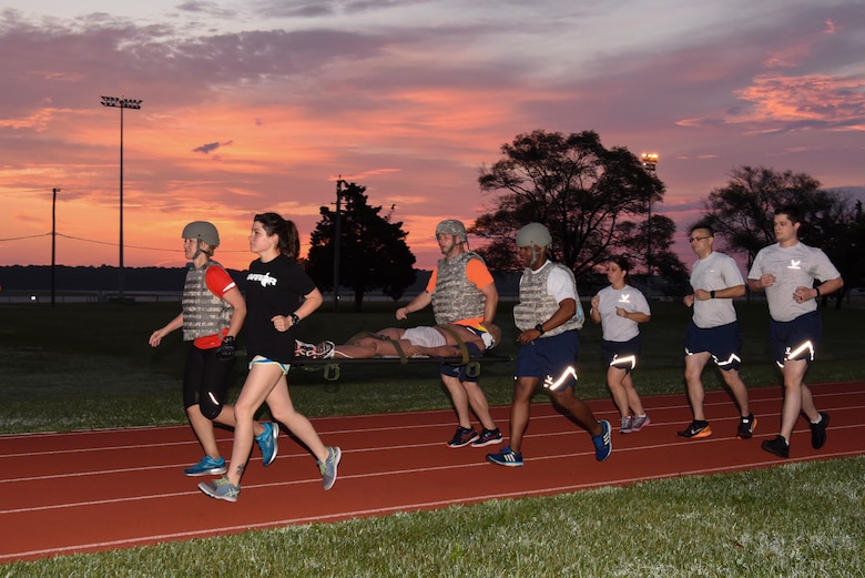 Medics assigned to the 436th Medical Group run with a litter and training dummy July 30, 2018, at Dover Air Force Base, Del., in preparation for the annual Emergency Medical Technician Rodeo at Cannon AFB and Melrose Air Force Range, N.M. This was the first time a team from Dover AFB competed in the rodeo, held August 7-10, which has been open to all Air Force bases since 2009. (U.S. Air Force photo by Staff Sgt. Aaron J. Jenne)