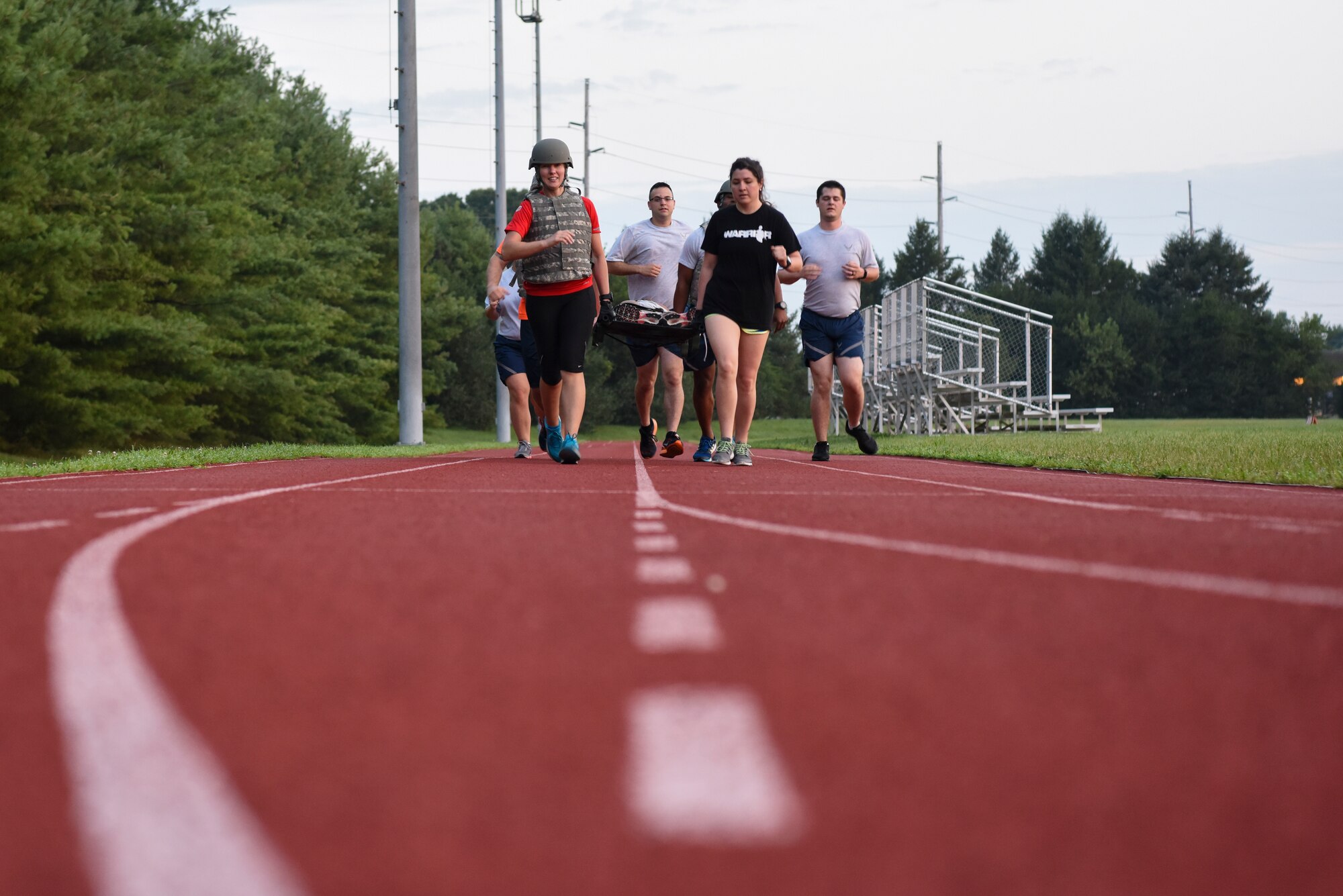 Medics assigned to the 436th Medical Group run with a litter and training dummy July 30, 2018, at Dover Air Force Base, Del., in preparation for the annual Emergency Medical Technician Rodeo at Cannon AFB and Melrose Air Force Range, N.M. During the rodeo, held August 7-10, the medics competed in land- and water-based rescues, and participated in several life-saving classes. (U.S. Air Force photo by Staff Sgt. Aaron J. Jenne)