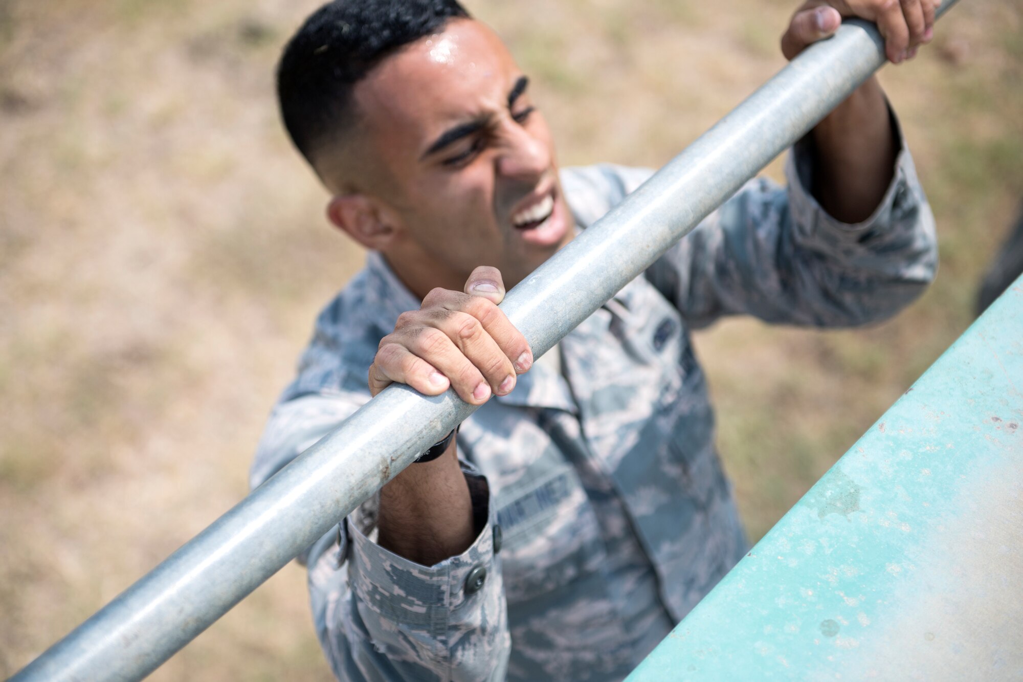 An Airmen performs an obstacle during an obstacle course