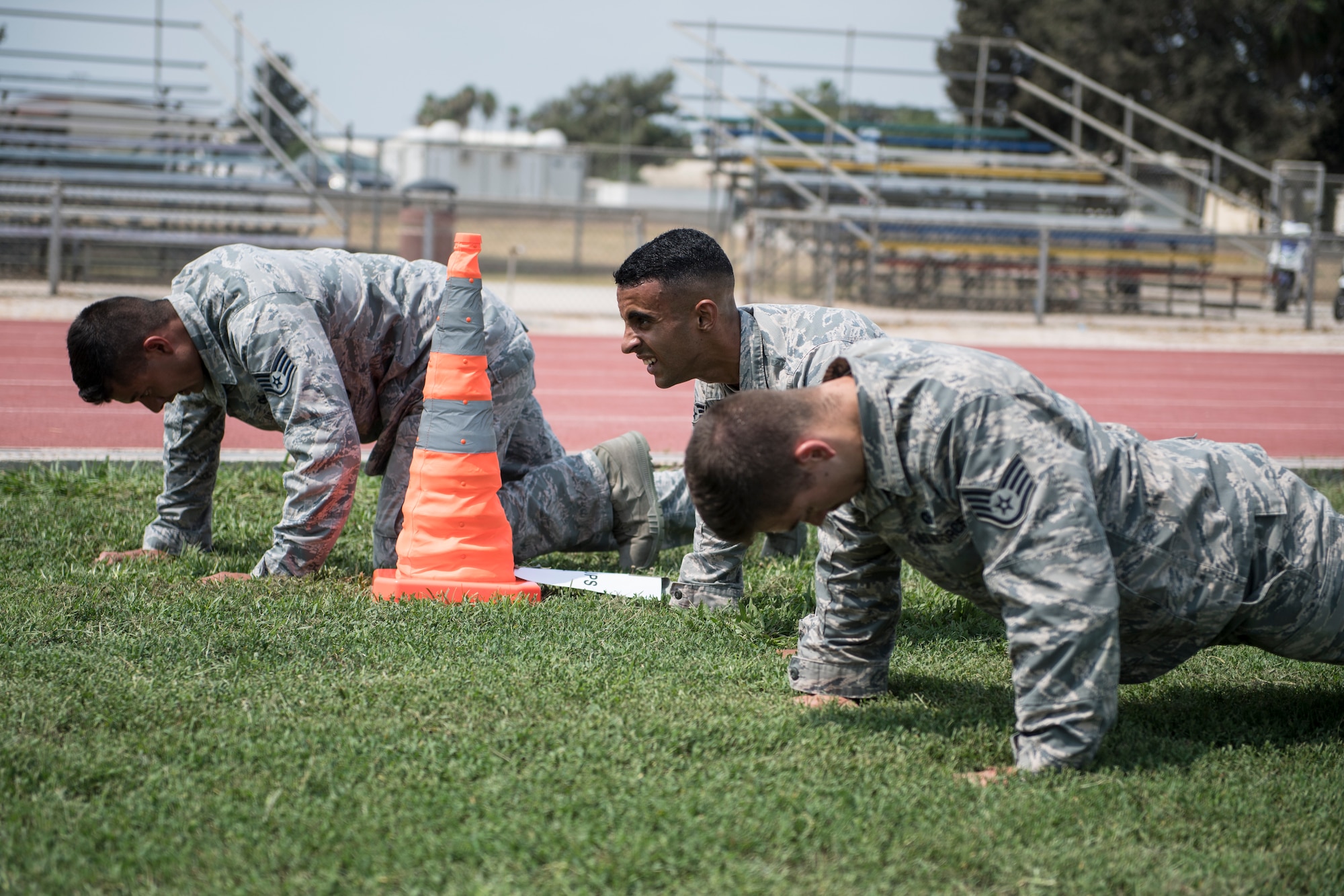 Airmen perform an obstacle during an obstacle course.