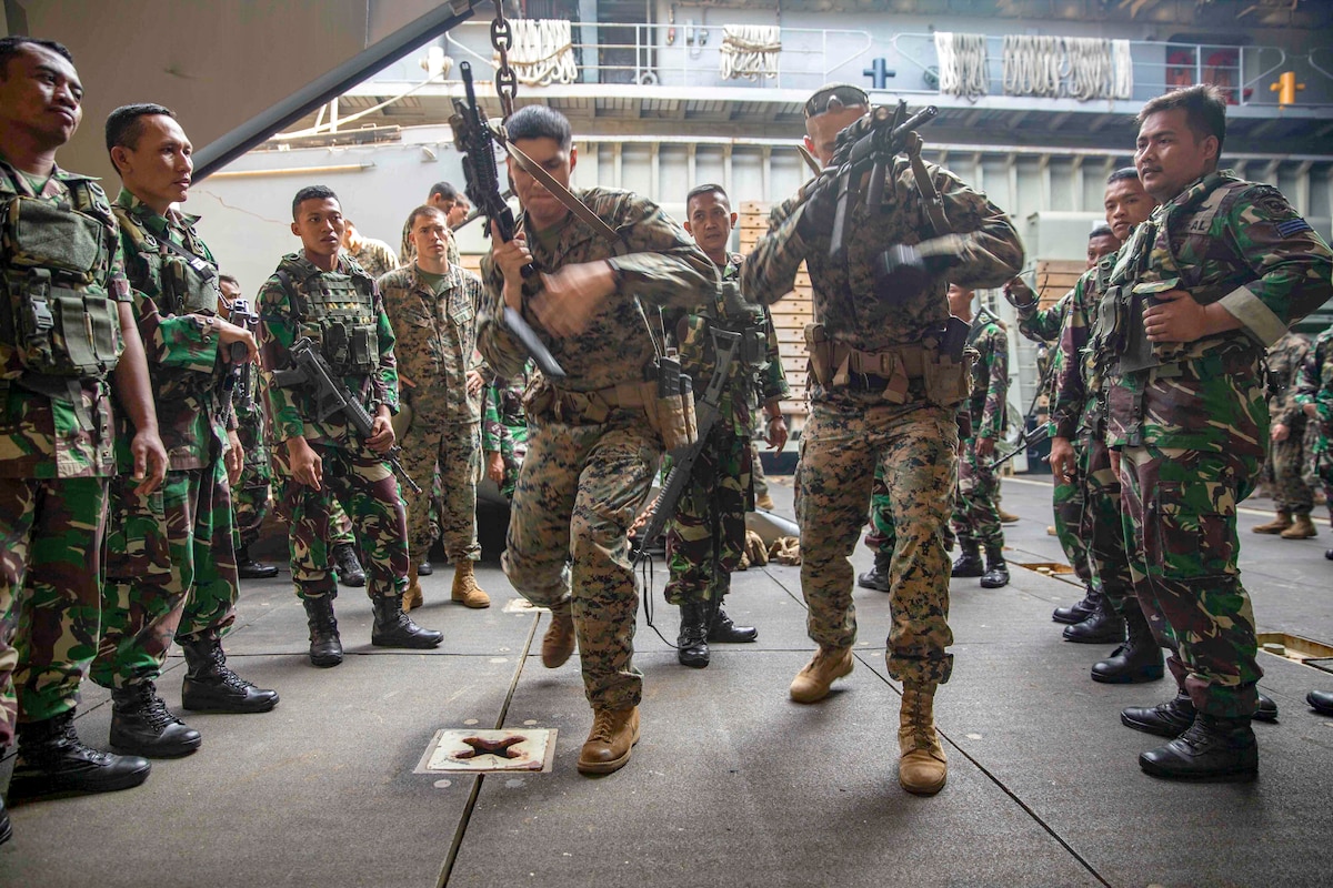 Marines demonstrate how to quickly reload their weapons.
