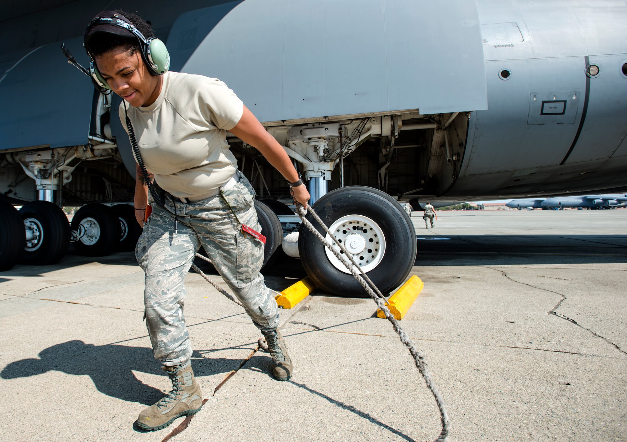 Airman 1st Class Amber St. Julian, 60th Aircraft Maintenance Squadron crew chief, removes chalks from the wheels of a C-5M Super Galaxy prior to launch on Aug. 11, 2018, at Travis Air Force Base, Calif. The 349th and 60th AMXS work together to launch aircraft in a seamless active duty and Air Force Reserve integration.