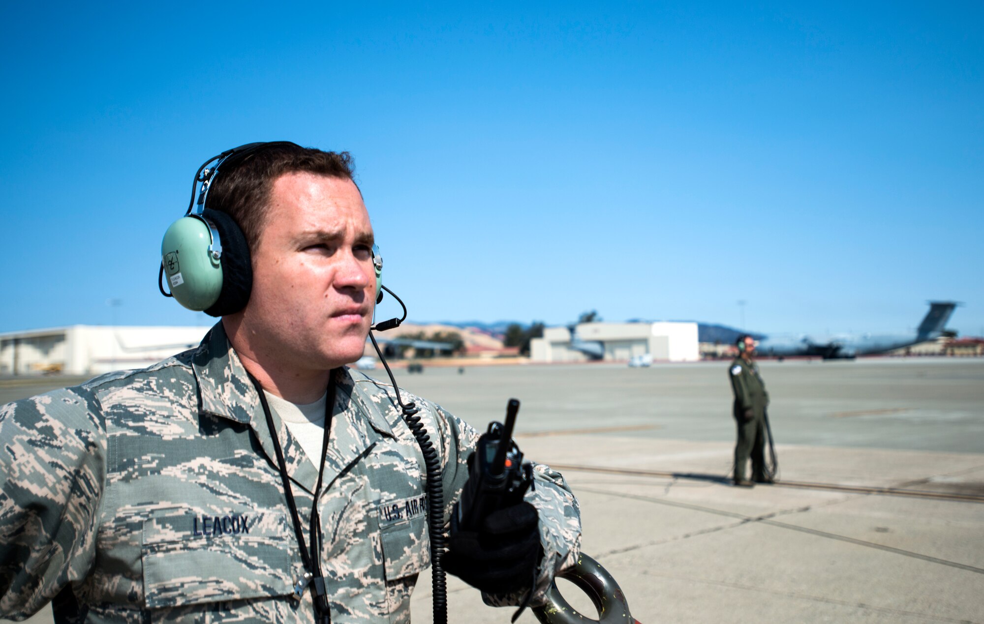 Staff Sgt. Taylor Leacox, 349th Aircraft Maintenance Squadron crew chief, listens to his radio to ensure a C-5M Super Galaxy is cleared to launch on Aug. 11, 2018, at Travis Air Force Base, Calif. The 349th and 60th AMXS work together to launch aircraft in a seemless active duty and Air Force Reserve integration.