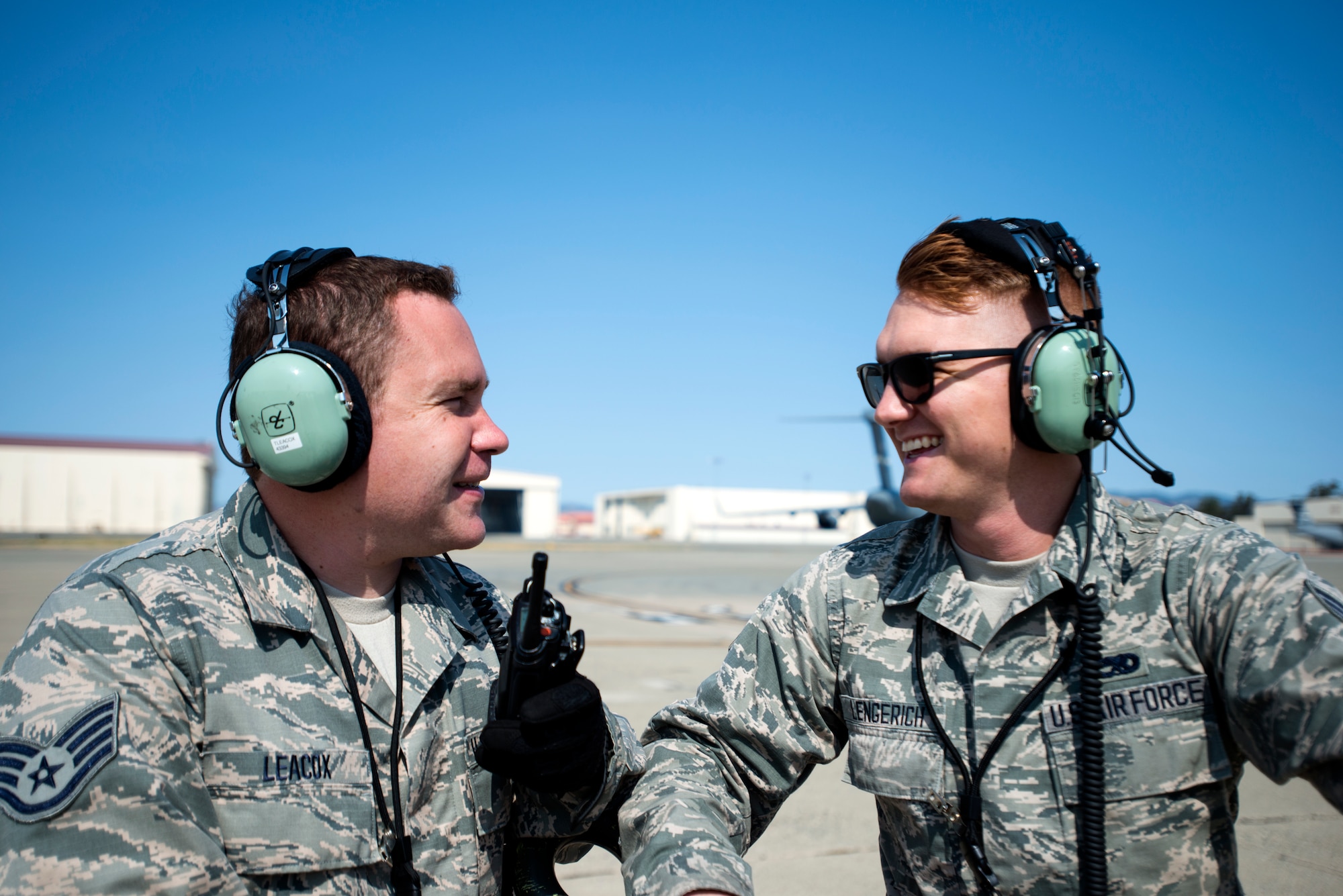 Staff Sgt. Taylor Leacox and Senior Airman Daniel Lengerich, 349th Aircraft Maintenance Squadron crew chiefs, discuss next steps to take before a C-5M Super Galaxy can launch on Aug. 11, 2018, at Travis Air Force Base, Calif. The 349th and 60th AMXS work together to launch aircraft in a seemless active duty and Air Force Reserve integration.