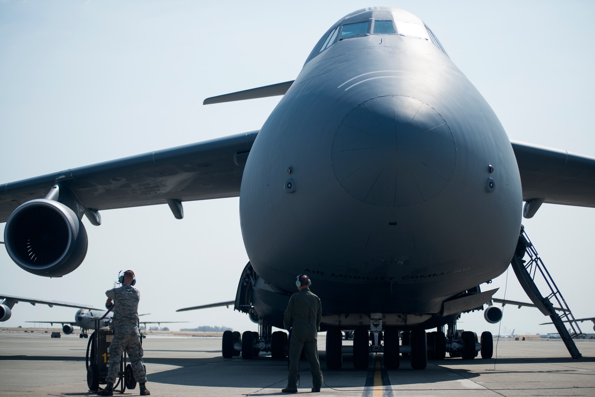 Crew chiefs for the 349th and 60th Aircraft Maintenance Squadrons stand by as the final checks on a C-5M Super Galaxy are completed prior to its launch on Aug. 11, 2018, at Travis Air Force Base, Calif. The 349th and 60th AMXS work together to launch aircraft in a seemless active duty and Air Force Reserve integration.